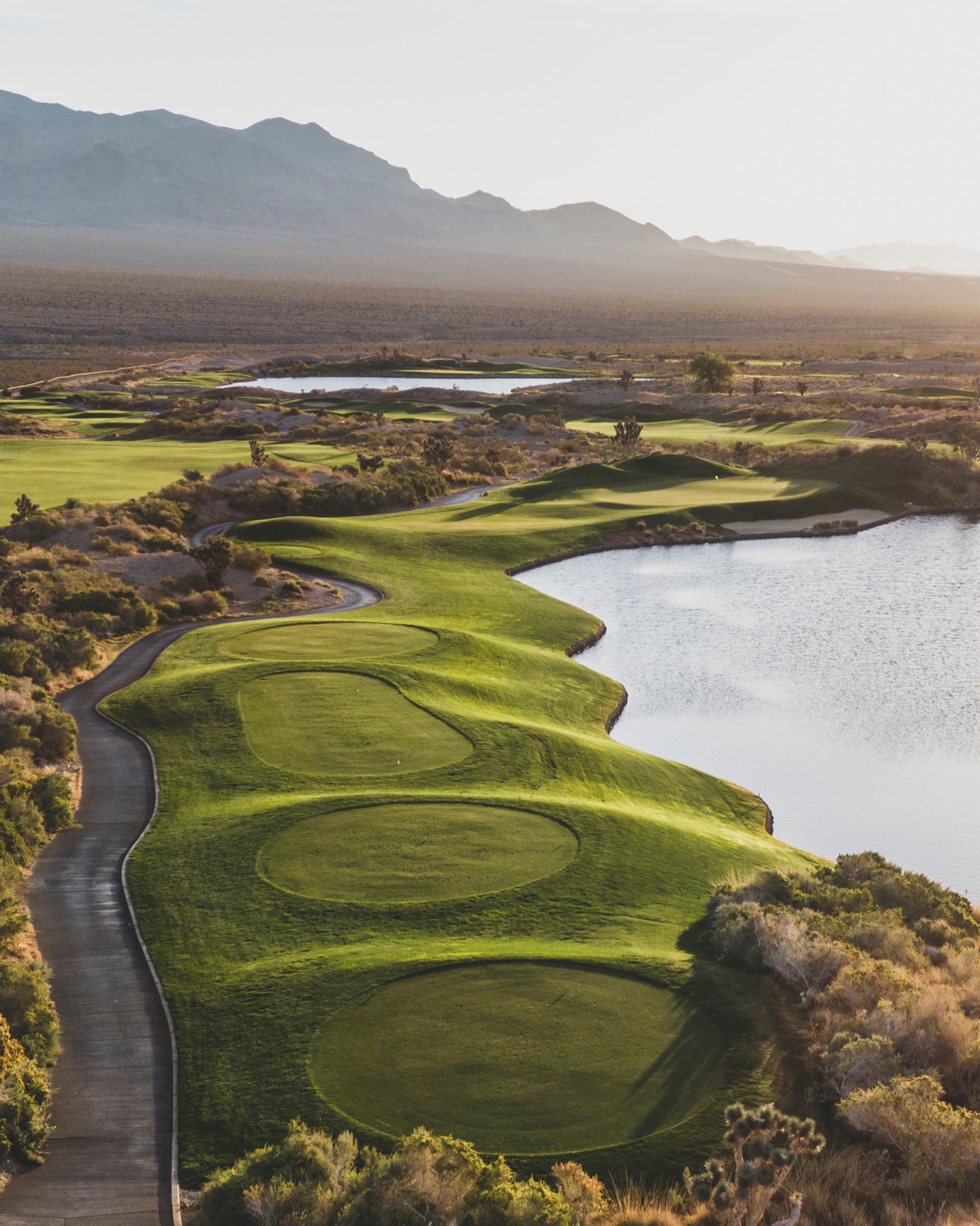 Spotlight Hole of the Day: Sun Mountain #4
This demanding Par 3 requires a long carry over water. With a bunker right and little bail out to the left, there is not much room for error. Hit it and hope......what club are you hitting?
#golf #desertgolf #petedye #sunmountain #lasvegasgolf #lvpaiutegolf