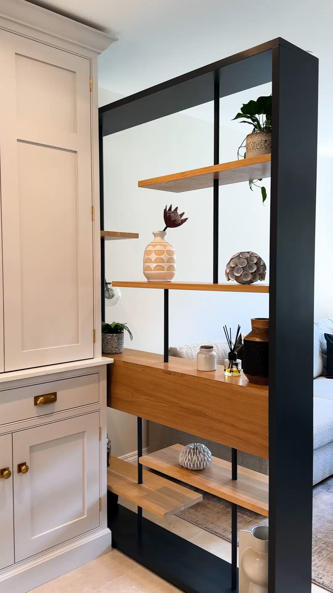 Open-plan living doesn't always need solid walls to define different functions. An open shelving divider creates subtle separation while maintaining natural light, visual connection and a greater sense of space. It provides just enough privacy without sacrificing the openness that makes these layouts feel so inviting. #BespokeDesign #KitchenInspo #InteriorDesign #ModernLiving