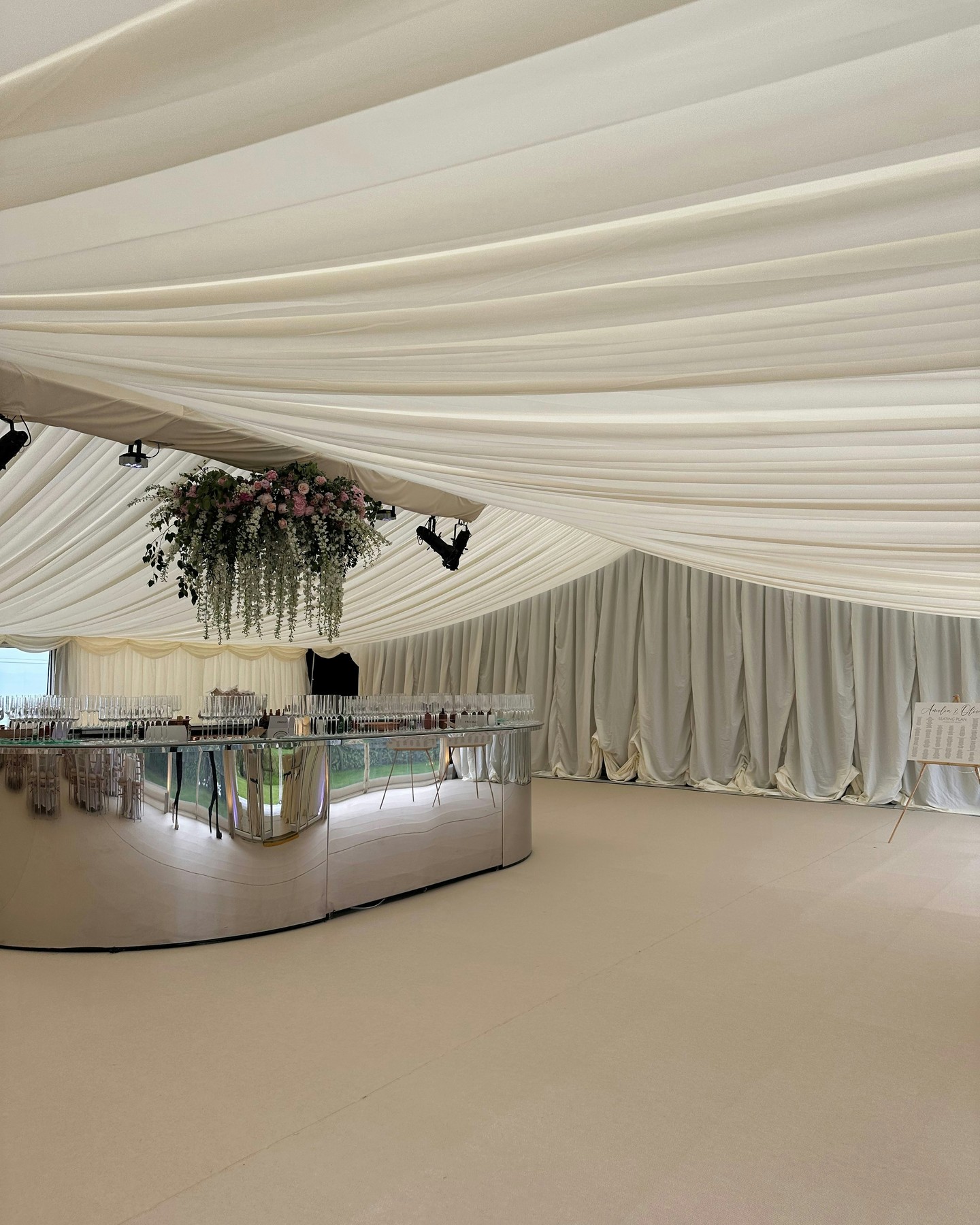 Make a statement 🤍🍸
Here's our gorgeous oval mirror bar, set inside a frame marquee dressed in ivory pleated lining and finished with a soft champagne carpet underfoot ✨
Topped with a breathtaking hanging floral display, blush roses, trailing greenery and a sweep of pastel blooms cascading from above.
It's all in the details. Every drape, every reflection, every petal designed to make guests pause the moment they walk in.
If you're looking to make a statement at your next occasion, look no further. Whether you need marquee hire, furniture, accessories, event management or all of the above, let's make your vision come to life.
Talk to the team on 01638 743860 or drop us a DM for more info✨
#mirrorbar #ovalbar #weddingbar #marqueewedding #luxuryweddings #framemarquee #weddinginspiration #bridetobe #weddingdesign #bespokeevents