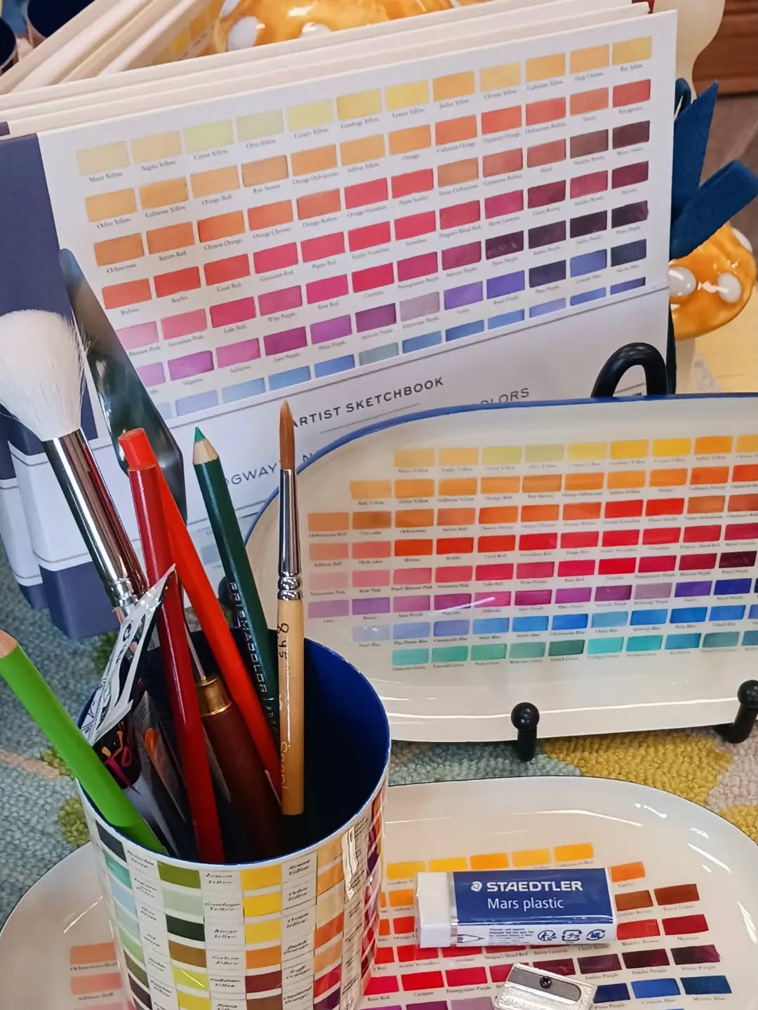 We love color! Sketchbooks, pencil cups & enamel trays available 🌈