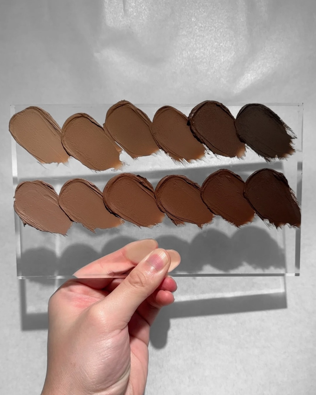 A little swatch party of all 12 shades of our Spectral Sunlight Cream Bronzer. Have never shown them off this way before, but aren’t they pretty all laid out like this?
If you’re newer here, these aren’t your typical bronzer or cream product. They’re not an immediate impact, bam in your face pigment kind of cream bronzer. These bronzers are designed to be swept and built on the skin in light layers.
It’s a translucent but super tightly knit formula so you get this really skin like finish that doesn’t “cover up” your skin or add an odd type of coverage that looks unnatural.
The shades were designed with different undertones in mind, and the right one will look so realistic on the skin that it won’t even look like you’re wearing bronzer.
Yes, they’re all very olive friendly. We designed them to be so years ago, well before the mass public started discovering the world of olive-ness recently. Every shade is balanced with blue, black, cool reds, etc to create the hints of green, neutrality, and coolness so they don’t look super primary and out of place on the skin.
Will probably add a couple of these photos to our website as well 🙂❤️☀️
#creambronzer #indiemakeup #oliveskin