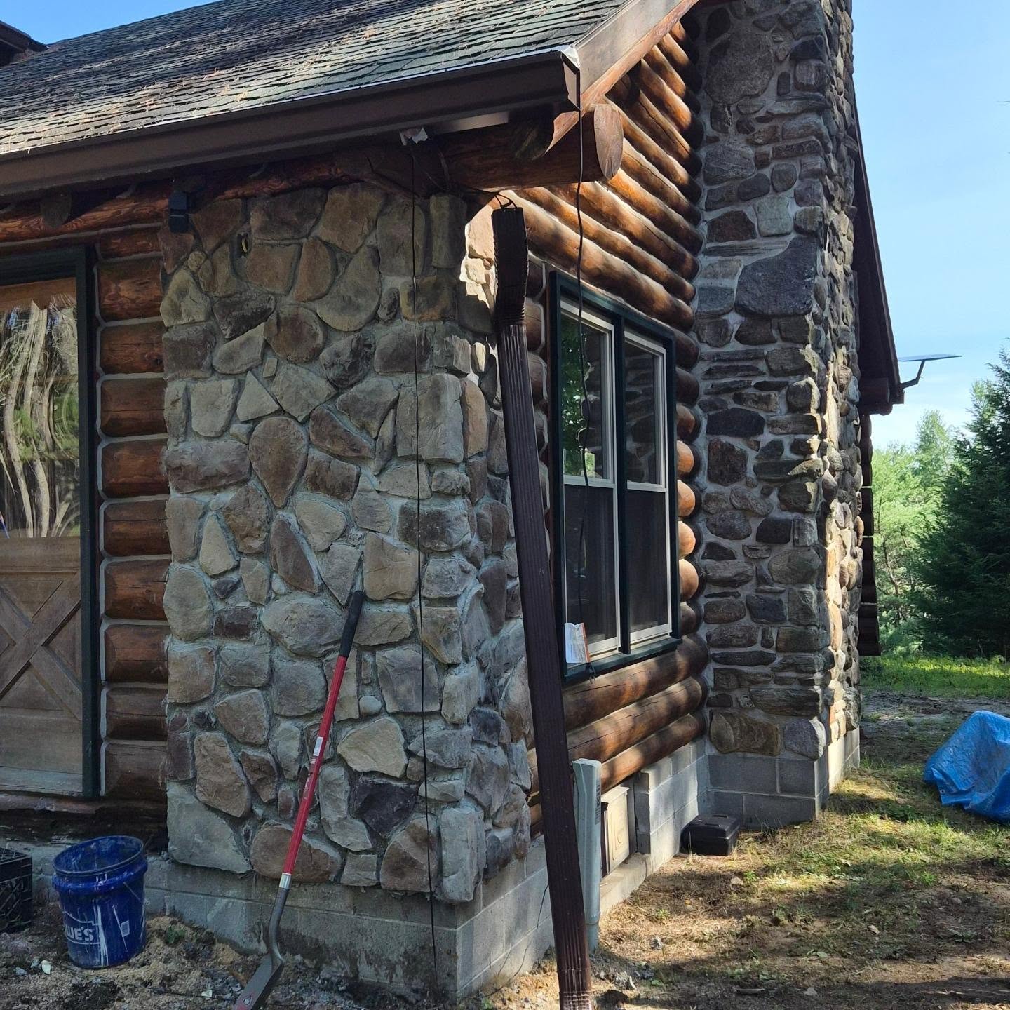 We repaired a corner of an off grid log cabin in Lake Luzurne that suffered 50 years of water damage to the corner of the home. We replaced the corner with conventional framing and a stone veneer both inside and out to match the style of the fireplace.