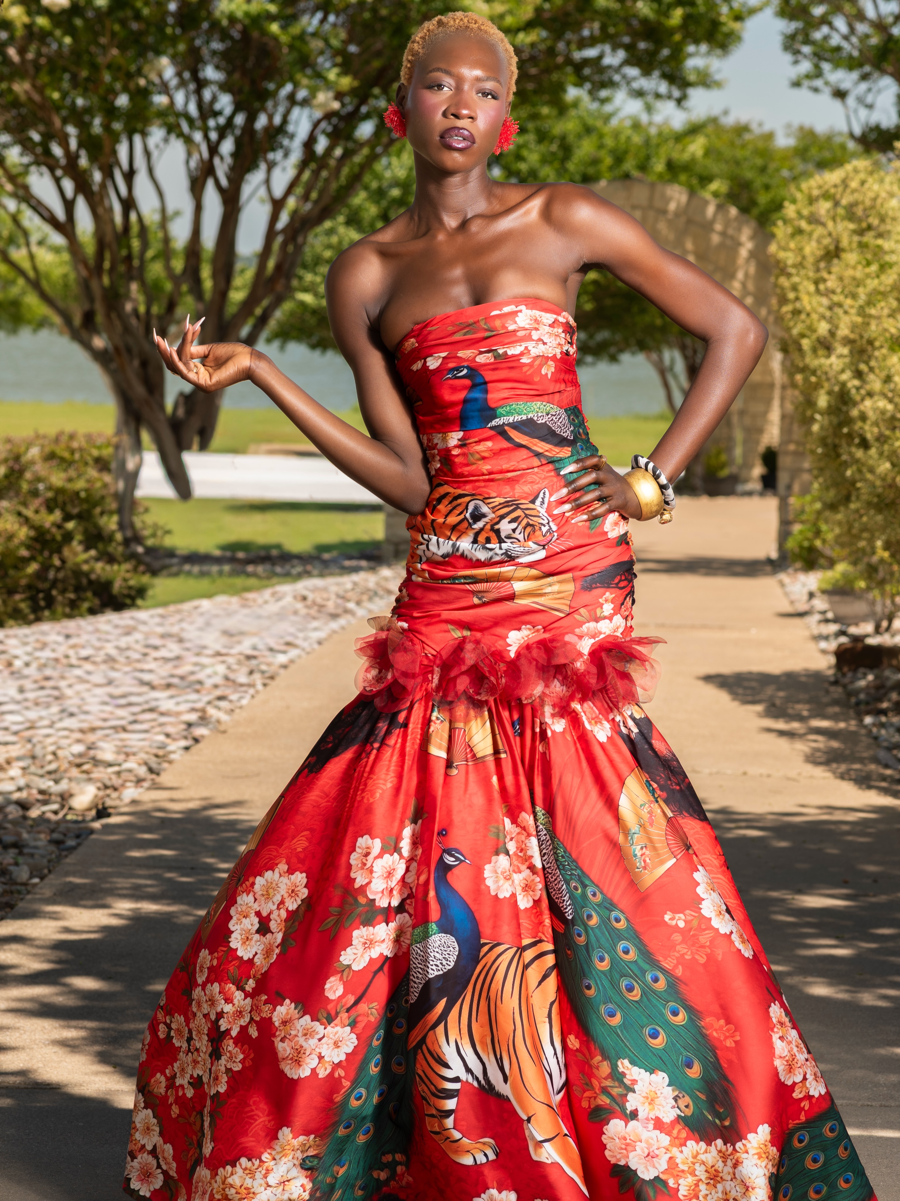 Every Annia Louisa creation begins with a pencil, a vision, and a destination waiting to be discovered.
The Kyoto Resort Evening Gown is the couture expression of our journey through Japan’s cultural heart. Inspired by the elegance and symbolism woven throughout Kyoto, this limited-release design tells a story through every carefully placed element. Majestic tigers embody courage and quiet strength, graceful peacocks represent beauty, prosperity, and renewal, while delicate cherry blossoms remind us of life’s fleeting beauty. Traditional Japanese fans complete the composition, honoring centuries of artistry and culture.
The dramatic mermaid silhouette, sculpted ruched bodice, and couture floral ruffle create a gown designed not simply to be worn, but to be remembered. Every motif was intentionally placed so the print unfolds like a living work of art with every step.
From the first sketch… to the final stitch… this is wearable art.
#annialouisa #luxuryresortwear #resortwear
Photography @beyondreachmedia
Muse @maevathemodel