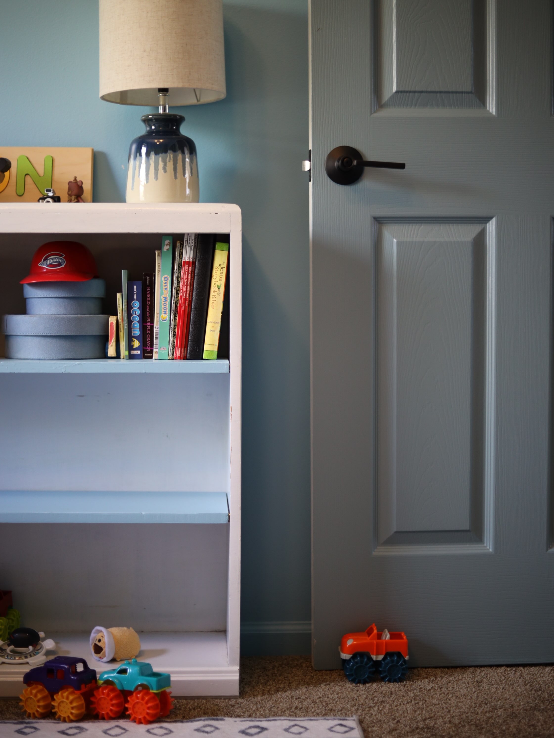 I tried designing my son’s nursery. I couldn’t. I was stuck. It’s the only time in my career that I have been really and truly stuck and couldn’t get a design to come together. So I decided to let it go and go with one decision that felt right. The blue walls. I had wanted his nursery to feel like a safari jungle, a peaceful forest, and a little Peter Pan/Swiss family Robinson. A versatile place for boys, toys, and a great imagination! But when I didn’t like any of the designs I mocked up, I just decided to paint the room a blue that inspired me and go from there. As soon as I walked into the painted room I sighed a sigh of relief. It felt right. I still didn’t know what I was doing but I now had somewhere to start. Then slowly it started coming together. A roman shade made out of a cloth my husband brought back from India plus the elephants that were over his crib. An heirloom giraffe kids coat rack made by Great Grandpa. Some forest and lake paintings we did during a wine and paint night here in Greenville. A dark green tent over where the crib would go, a fish net of stuffed animals (inspired by a Scene from the @hookmovie ), an oversized stuffed animal alligator Jonathan won as a kid at the dentist, and a large teddy bear from Nanna. It’s not the most designed nursery in the world, but it is oh so special! Filled with fun, imaginative details and delightful pieces inherited from family, Mason’s room finally felt like the peaceful, adventurous, outdoorsy, tree-house/safari inspired room I always wanted for him. Sometimes you have to take the not-so-perfect approach in order to get a space that feels personal and meaningful. And that’s how it should be. We don’t need perfect palaces, we need homes full of delightful details and joyful memories that make space for more special moments with those we love! #nurserydesign #greenvilleinteriordesign