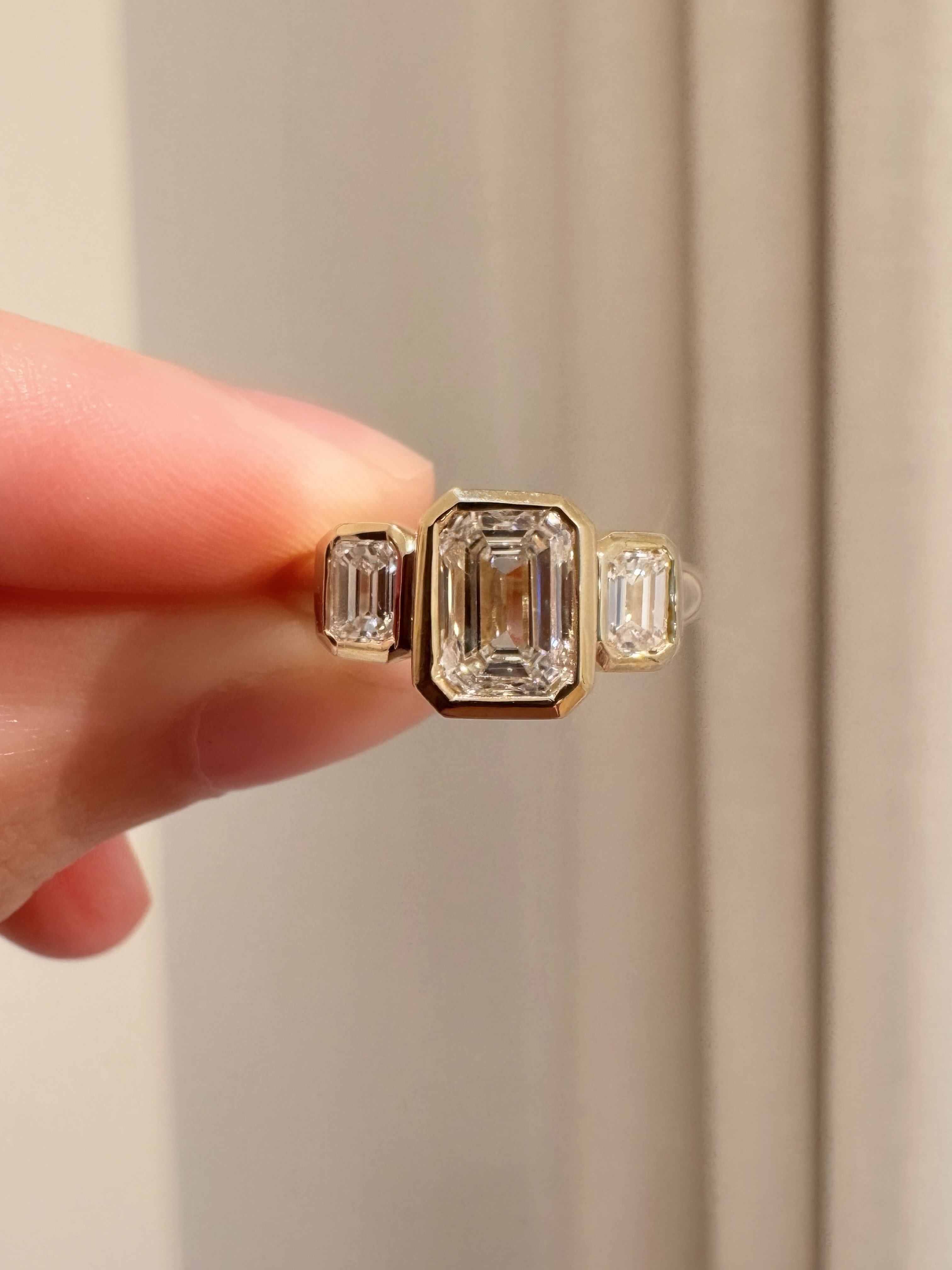 Just completed this 3-stone emerald cut engagement ring reset for a client who previously had the same stones set in a classic white gold prong setting. After 10+ years it felt like the right time for a little renovation and we went with a yellow gold bezel with rounded edge band ❤️ Emmerson domed band to round out the whole look ❤️