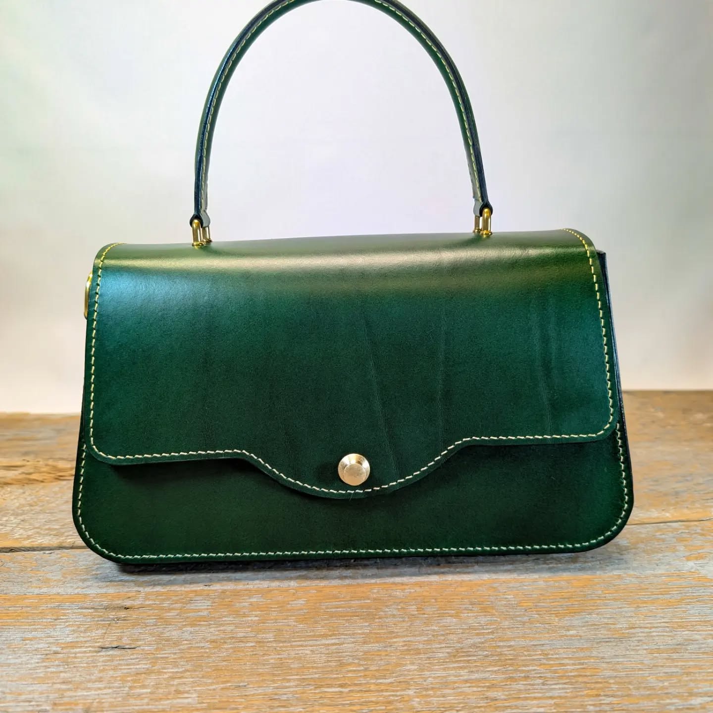 The Victoria. Green Buttero leather with calf skin lining, solid brass hardware, pinch lock closure.