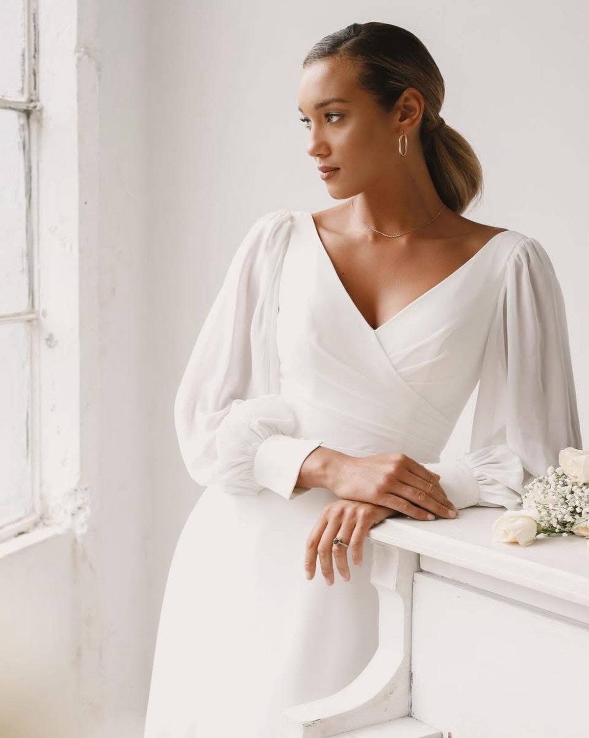 Clean and effortless, this flowy chiffon bridal gown features a modest V-neckline accented with flattering pleating across the front and back of the bodice. The light chiffon bishop sleeves add a fashion-forward touch to this soft look. The simple A-line skirt complete with a chapel length train will ensure you’re comfortable all day long.
@sinceritybridal - Style 44264
#bishopsleeve #weddingdresswithsleeves #floatydress #hampshirebride #surreybride
