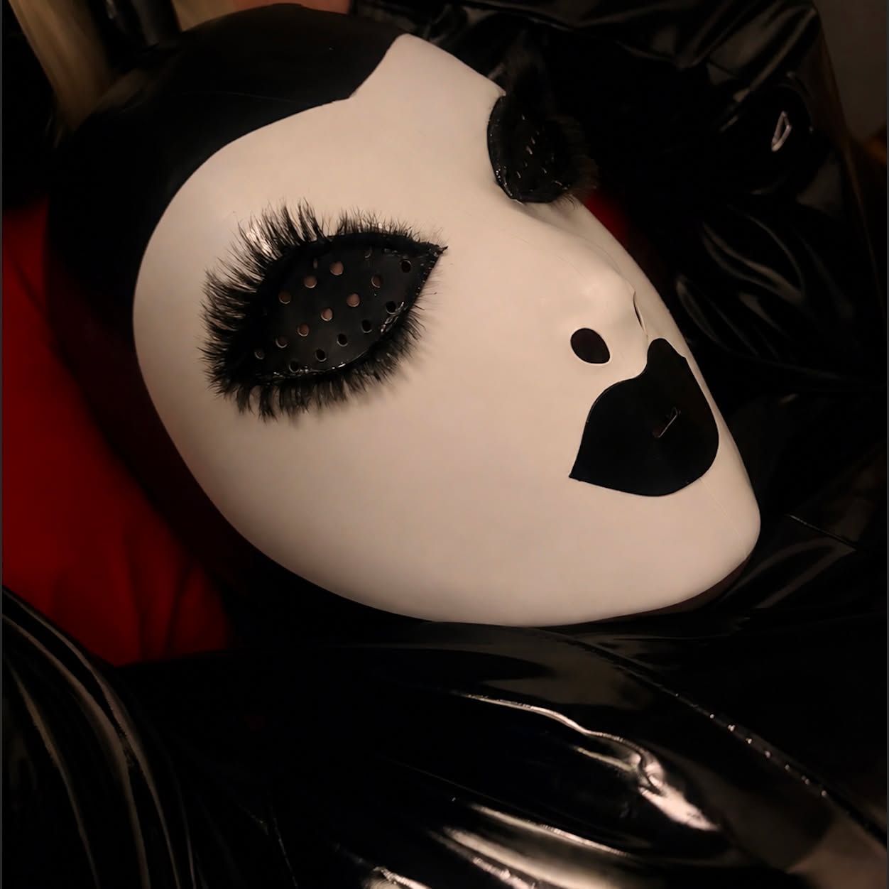 I made this mask for my Hubby. I used black liquid latex long lashes edge, allowing me to glue the lashes on to the mask. I kissed a piece of paper and cut out my lip shape. I think this latex mask looks cool! I added a long blonde ponytail but he was struggling with it getting in the way aww. #latex #latexmask #latexhood #rubberhood #latexfetish