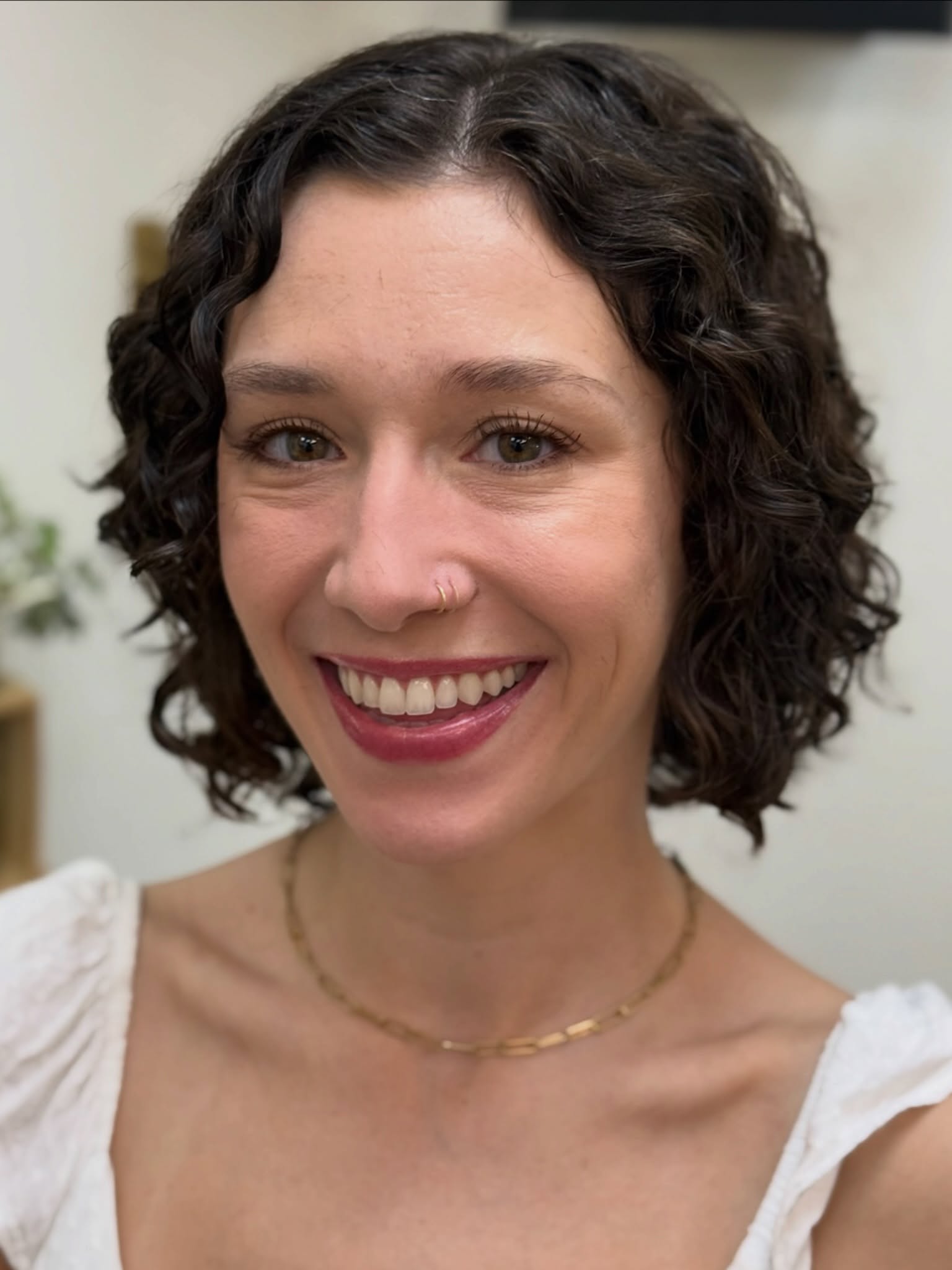 A Curly Cut vs Traditional Cut
A curly haircut distinguishes itself from a traditional haircut in several key ways. As a Curl Specialist, my approach to a curly haircut involves specific techniques:
Firstly, I perform a Dry Cut, a departure from the conventional wet hair cutting method. Dry hair enables me to clearly observe the natural curl pattern and tailor the cut accordingly.
Secondly, I employ a Customized Cutting Technique designed exclusively for curly hair. This technique entails meticulously cutting each curl individually, preserving and enhancing its inherent shape, unlike standard methods that may disrupt the curl pattern.
Thirdly, Texturizing techniques play a pivotal role. Depending on the client’s hair type and texture, I may use techniques like point-cutting or slide-cutting to introduce movement and definition.
Lastly, I finish with Product Application, using specialized products crafted for curly hair. Lightweight gels, mousses, or creams are applied post-cut to enhance and define the curls, completing the transformation.
Through these tailored techniques and personalized attention to each client’s unique hair, I strive to deliver a curly haircut that elevates their natural curl pattern, resulting in stunning, well-defined curls.