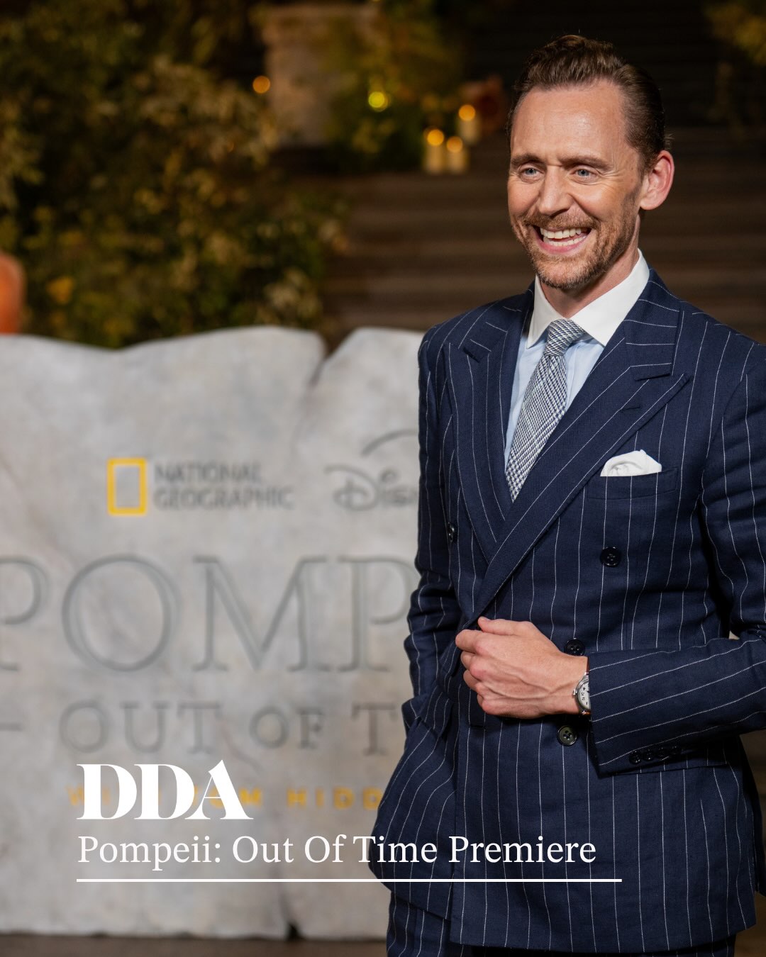 DDA Live were pleased to return to the British Museum to deliver the World Premiere for ‘Pompeii: Out of Time with Tom Hiddleston’ for National Geographic & Disney+.
During a speedy hour’s set up, the team pulled together a beautiful talent photography moments, featuring a carved stone, foliage and Roman dressing, a screening and Q&A for 300 guests and a beautiful drinks reception complete with a 4m tall olive tree centrepiece.
Combined with the perfect English summer weather, the evening was a roaring success!
