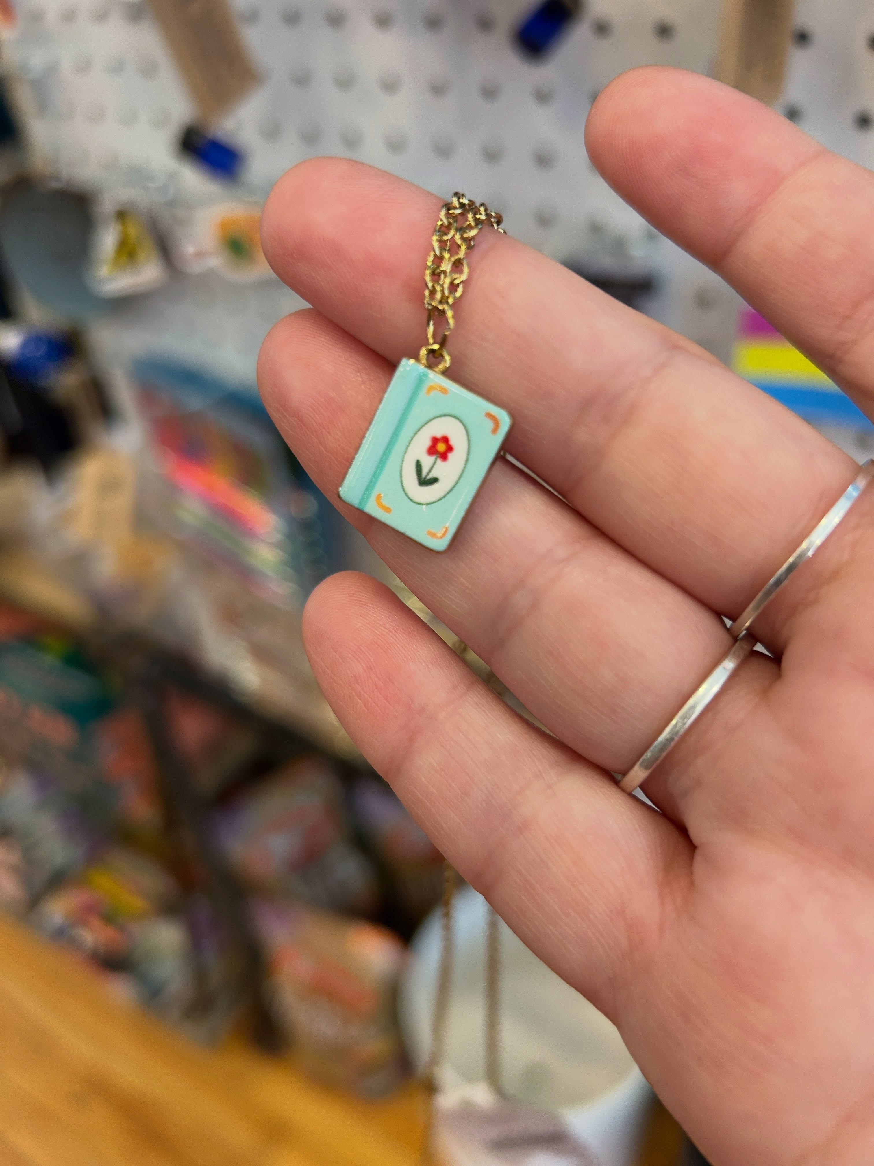 Good afternoon! It’s Sunday, how are we feeling today? I decided to walk around and see what struck my fancy, and these three goodies are what I found - a book necklace, a softly pin, and a sunflower sticker. Have a great day!