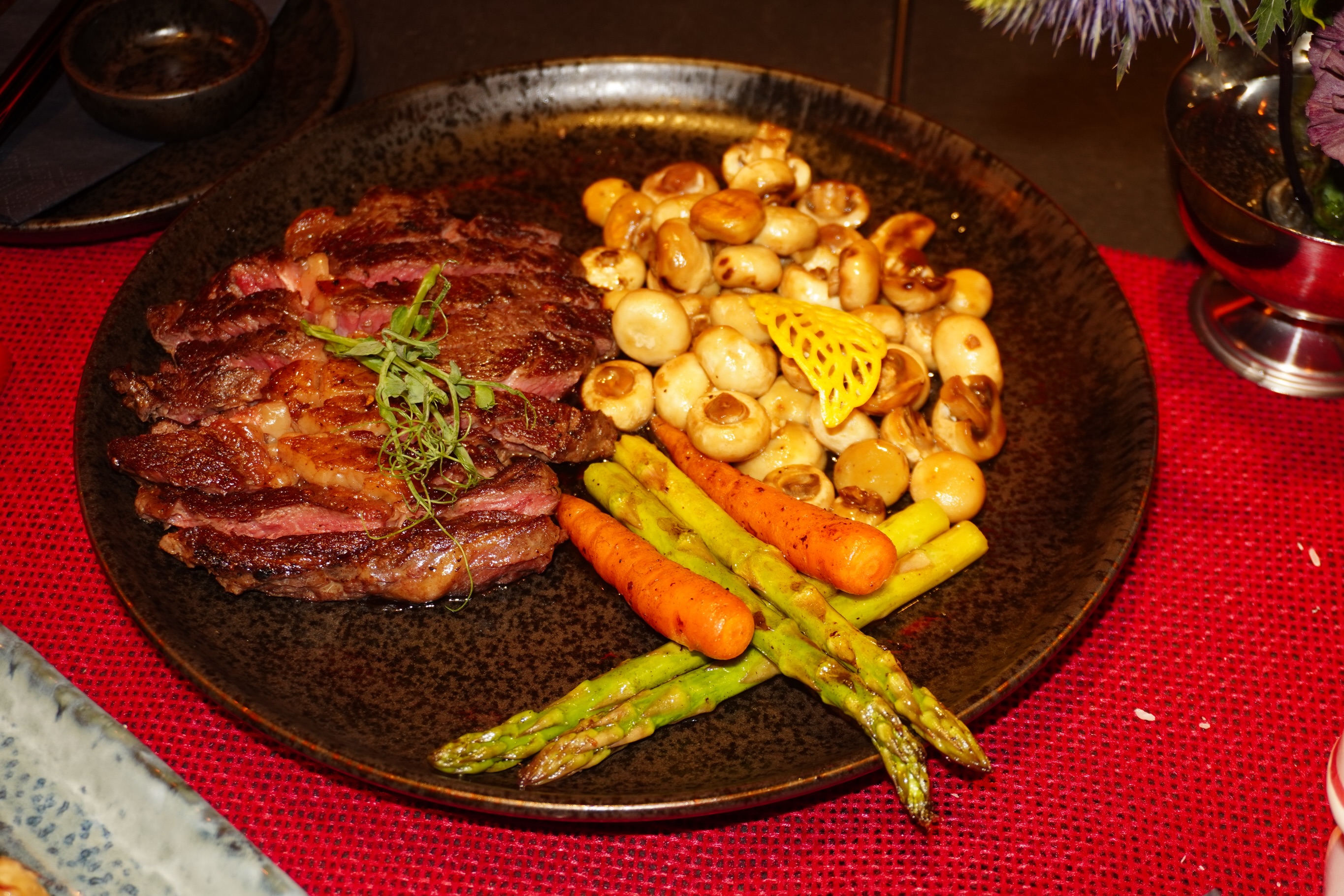 Beef steak, seared and served with a Japanese-style black pepper sauce, buttery mushrooms and seasonal vegetables. Rich, peppery and deeply savory.