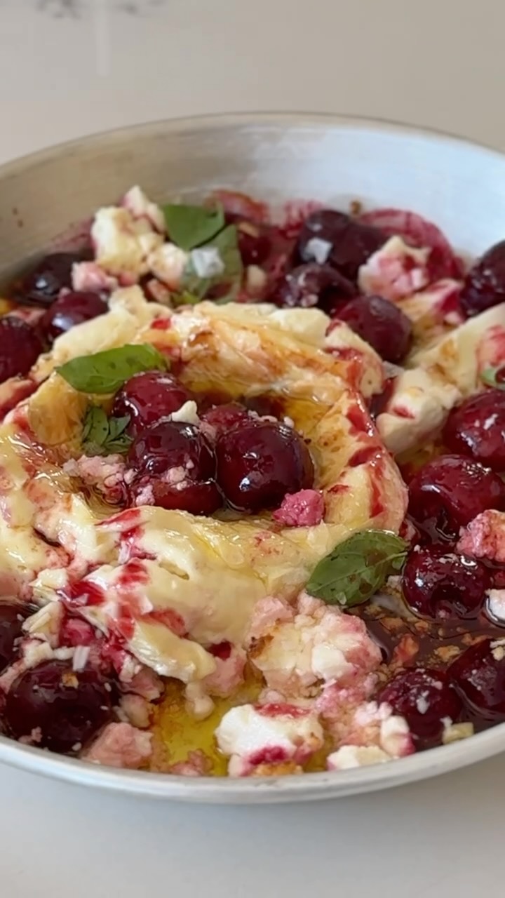 BAKED BRIE WITH CHERRIES & FETA
Cherries! It’s the tail end of the season, so make this baked brie, which I jacked up with feta and pomegranate molasses (because, Adeena). It comes together fast. Scoop up the melty, bubbling cheese and cherries with some crusty bread and watch the compliments come.
Serves 4 as appetizer
A 5-ounce wheel of brie
4 ounces crumbled feta cheese
½ cup sweet cherries, pitted
Drizzle of olive oil
2 teaspoons pomegranate molasses, plus more to taste
1 teaspoon balsamic vinegar, plus more to taste
Fresh basil, for garnish
Flaky sea salt
Toasted baguette slices, for serving
Preheat the oven to 350°F.
Place brie in the center of a small, round, oven-safe dish. Sprinkle feta and cherries around the brie and drizzle with olive oil. Bake until the brie is slightly browned and bubbling, about 20 minutes. Drizzle with pomegranate molasses and balsamic, then top with basil and flaky salt. Serve with toasted baguette.