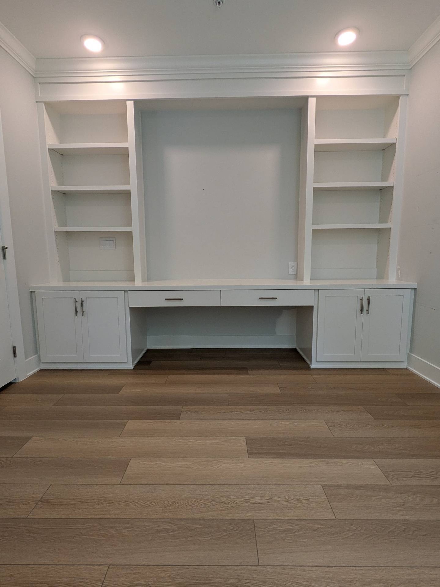 A blank wall became a home office designed around how this client actually works.
We built a full-wall desk with generous workspace, concealed cabinet storage, drawers for everyday essentials, and adjustable shelving for books and décor.
One of the most practical details is hidden inside the left base cabinet: a rollout designed specifically for the printer. It keeps bulky office equipment accessible without leaving it out on the countertop.
We also left a large open area above the desk so the homeowner can add a monitor, artwork, a pinboard, or whatever best supports her daily routine.
Custom cabinetry is not just about filling a wall. It is about creating a space that makes life easier, keeps clutter under control, and feels like it belongs in the home.
Swipe through to see the details—and the blank wall where it all began.
#RaleighWoodworks #CustomHomeOffice #BuiltInDesk #OfficeBuiltIns #CustomCabinetry #HomeOfficeDesign #StorageSolutions #CustomWoodworking #RaleighNC #BeforeAndAfter