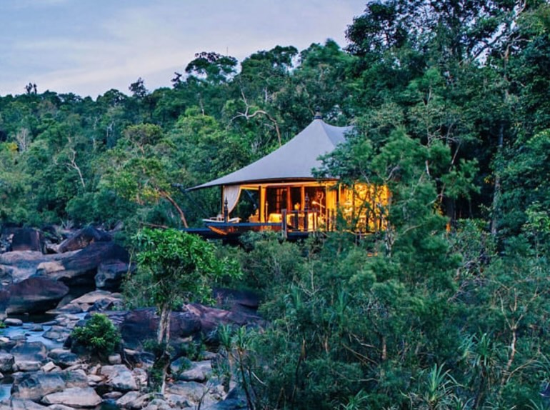 Tucked into a mile-long stretch of protected jungle between two national parks in Cambodia, this Bill Bensley-designed camp is one of the most special properties I get to recommend. Only 15 tents on the entire property, each one perched over the river or jungle, fully air-conditioned, with an outdoor bathtub and a mini bar stocked and ready. And then thereâs this pool â carved right into the jungle canopy, easy to miss itâs even there until youâre floating in it.
Every stay is fully all-inclusive: meals, transfers, jungle trekking, cycling, kayaking, a river boat ride, and sundowners served twice a week at a secret location that changes with the trip. I always recommend a minimum of three nights here â youâll want the time to actually slow down.
This is what I mean when I say travel can be a force for good â thoughtful design, deep sense of place, and a real commitment to the community itâs built within.
Planning a trip to Cambodia? This one belongs on the itinerary. DM me to start planning. đ