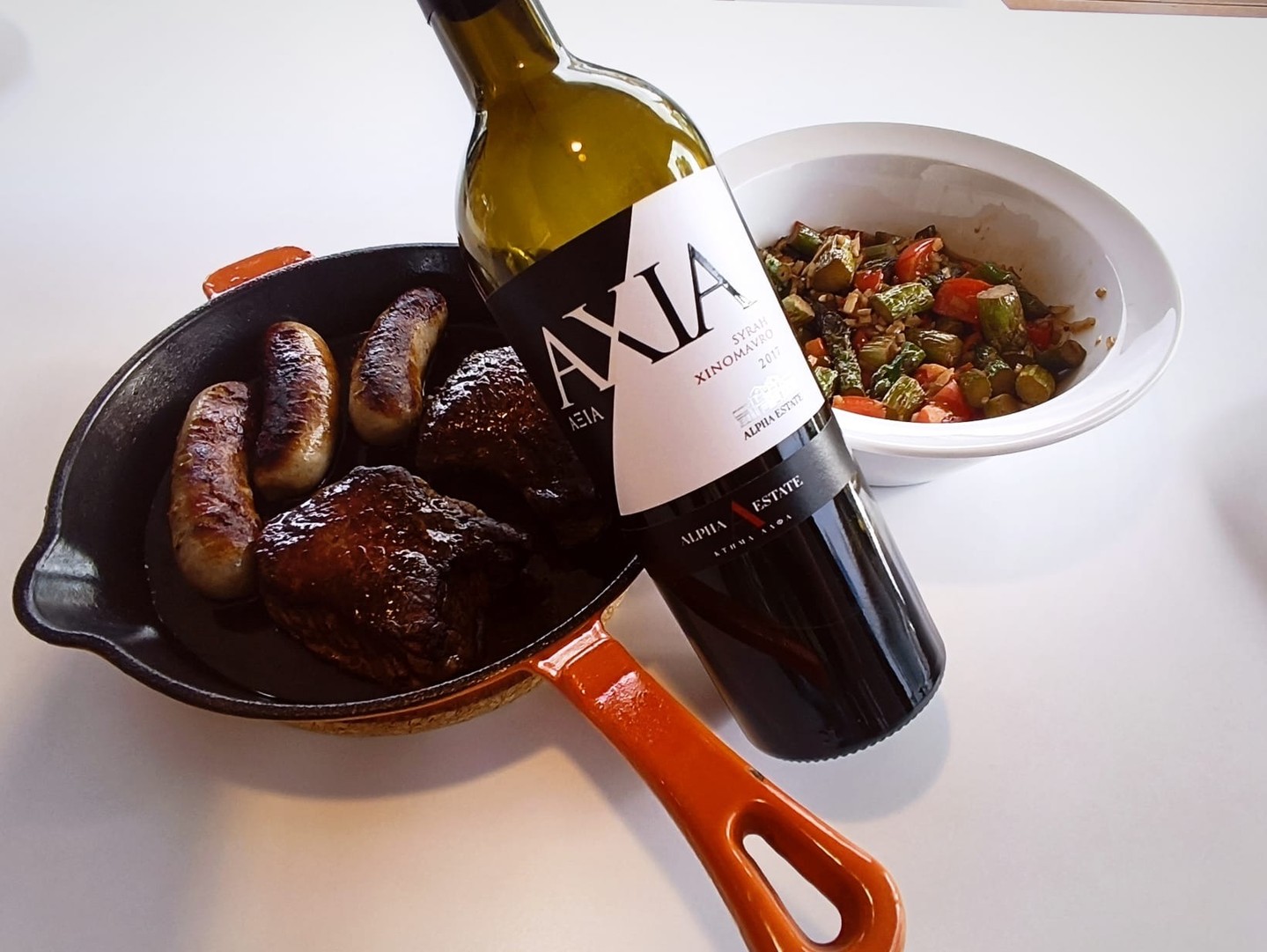 A twelve-euro Greek red I've been following for five years
Alpha Estate Axia 2017 – Florina, Macedonia | 89/100 🍷
Axia is Greek for "value", and Alpha Estate (@alpha_estate) means it: half Xinomavro, half Syrah from the cool high plateau of Amyndeon in north-western Greece, twelve months in Allier oak, another year in bottle before release – all for around 12 euros. Because the Syrah share rules out PDO Amyndeon, which demands pure Xinomavro, the wine goes out as PGI Florina. The idea is simple: Syrah brings dark fruit, pepper and body, Xinomavro brings acidity, tannin, red fruit and the backbone for ageing.
As a vintage, 2017 was dry and early in Amyndeon, with hail in some sites but strong quality overall – Xinomavro and Syrah both ripened well.
In 2021, at four years old, this was a fruit bomb with real structure – 92 for me, and one of the best value buys I knew; it was even under 10 euros when I bought this vintage. In 2024, at seven, it was still surprisingly fresh: 90+. Now, at nine, the raspberry on the nose still recalls the wine it once was, with a touch of strawberry. On the palate the Xinomavro structure stands out because the wine beneath has flattened; you feel your way along the tannin, ask yourself whether there is something faintly metallic in there, and the finish leaves acidity above all. Not much tertiary yet – a little caramel, a hint of sage.
So drink it now, and enjoy it now – it won't improve, but at this price it never had to. 89/100.
Full note in our database – link in bio.
Xinomavro's grip or Syrah's dark fruit – which camp are you in? 👇
#GreekWine #Xinomavro #Syrah #Amyndeon #ValueWine