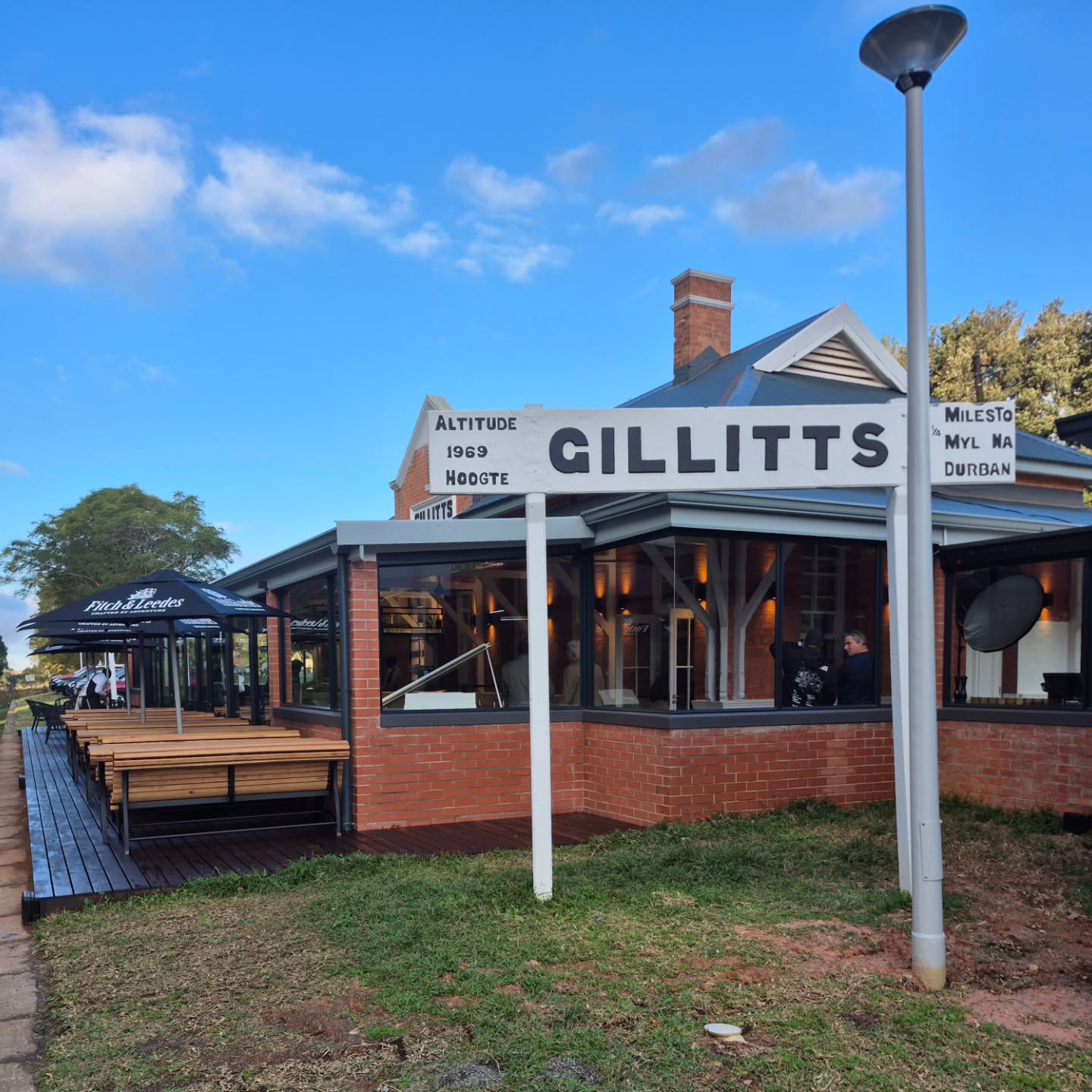 Gillitts Station has stood for generations, and it's so good to see it finally being returned to its former glory.
Working on a listed historical building comes with serious weight. The regulations are clear: no demolition, no structural alteration, no deviation from its original form. It has to be preserved exactly as it was built. Being trusted to contribute to that restoration, and play a part in keeping an old piece of history alive, is a privilege that doesn't come around often.
The new owner also owns Zula Beach in Richards Bay where, as some might know, we had previously been entrusted with building over 300sqm of decking for him. When Mist opened at Gillitts Station, we were glad to be a part of this historic project.
The brief was a CCA treated pine deck, tinted and sealed with deep brown Timbalife Satinwood 28. We returned just before opening day to give it one more coat. We also built a swing gate in Ofram to complete their bar space.
The site came with some constraints: the train tracks run directly behind the station. The line used to run the famous weekend train route starting from Stokers in Kloof and going all the way up to Inchanga Station, until floods washed away sections of the track. It may run again one day, or it may not - either way, the deck had to be kept clear of the rail corridor, which meant precise placement and careful measurement throughout, all within the boundaries of heritage regulations as well.
Restoration work isn't about leaving your mark. It's about making sure the building's mark endures. We're grateful to have played our part.
Contact us if you have a restoration project in mind.
#HistoricalRestoration #Decking #GillittsStation #MistRestaurant #MistyMountainTimberWorks