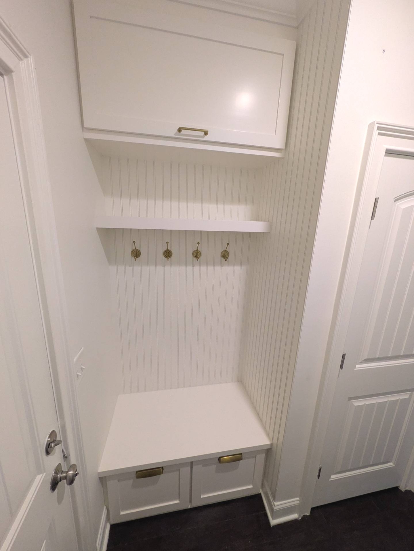 Swipe to see the before. ➡️
A well-designed drop zone can completely change the way you use your home.
What was once a simple alcove with a basic coat rack is now a custom-built storage solution featuring overhead cabinetry, beadboard detailing, a built-in bench, concealed storage, and durable hooks to keep everyday essentials organized and within reach.
Finished in Sherwin-Williams Westhighland White and accented with classic brushed gold hardware, this space is both functional and timeless—proof that even a small area can make a big impact.
Because the first thing you see when you walk through the door should be welcoming... not clutter.
#BeforeAndAfter #DropZone #Mudroom #CustomCabinetry #BuiltIns #HomeOrganization #Craftsmanship #CustomWoodworking