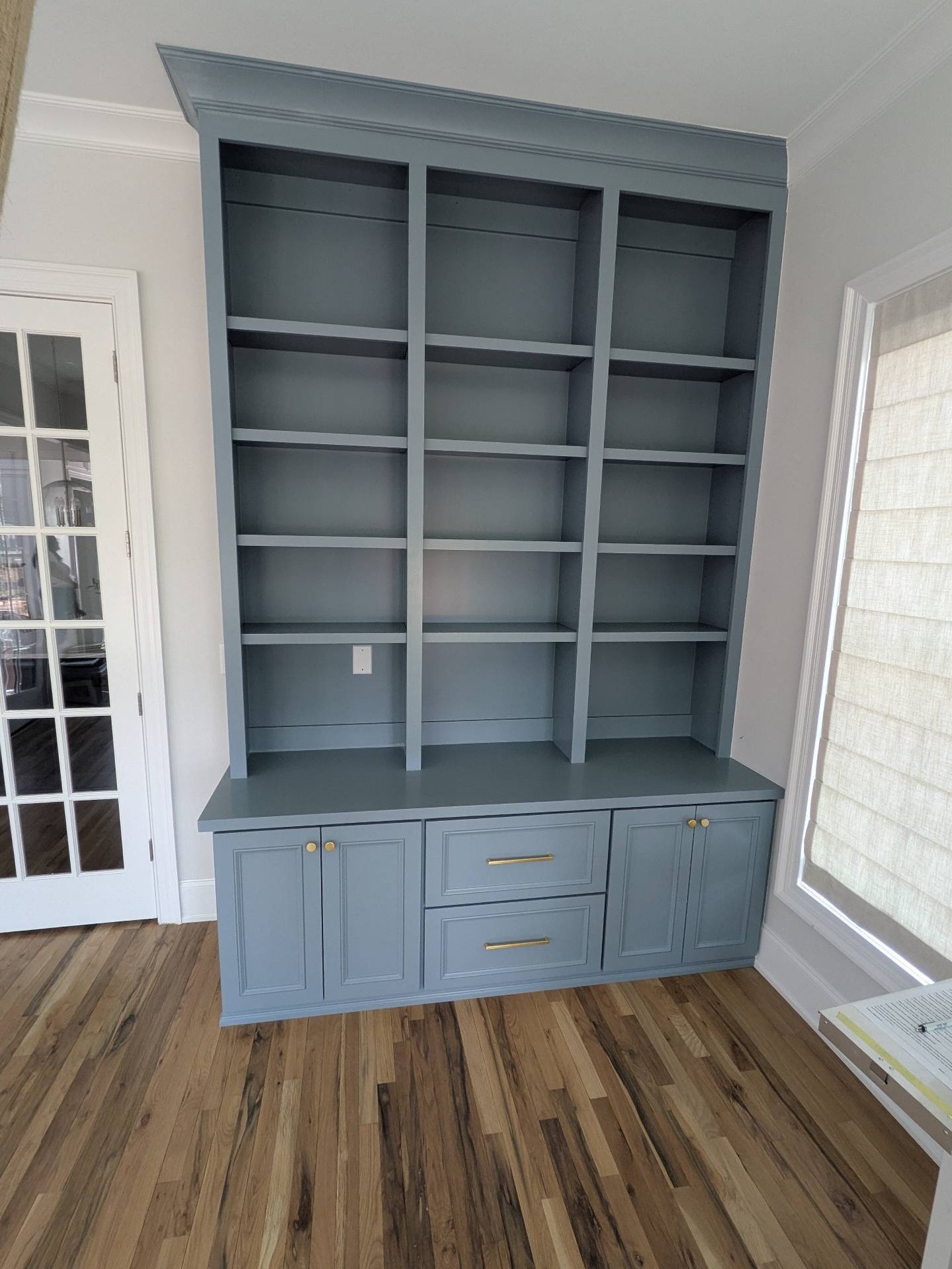 Not every home office has room for sprawling desks and oversized furniture—but that doesn't mean you have to compromise on storage or style.
For this project, we designed and built these custom floor-to-ceiling office built-ins to make the most of a smaller space. The combination of open shelving, concealed cabinet storage, spacious drawers, and integrated power creates a workspace that's as functional as it is beautiful.
Finished in the calming Van Courtland Blue and accented with brushed gold hardware, this built-in transforms the room into a place that's organized, productive, and inviting.
Every home is different, which is why every piece we build is thoughtfully designed to fit the space—and the people who use it.
✨ What would you display on these shelves?
#CustomBuiltIns #HomeOffice #CustomCabinetry #BuiltIns #HomeOfficeDesign #InteriorDesign #Craftsmanship #RaleighNC #NorthCarolinaHomes #WorkFromHome