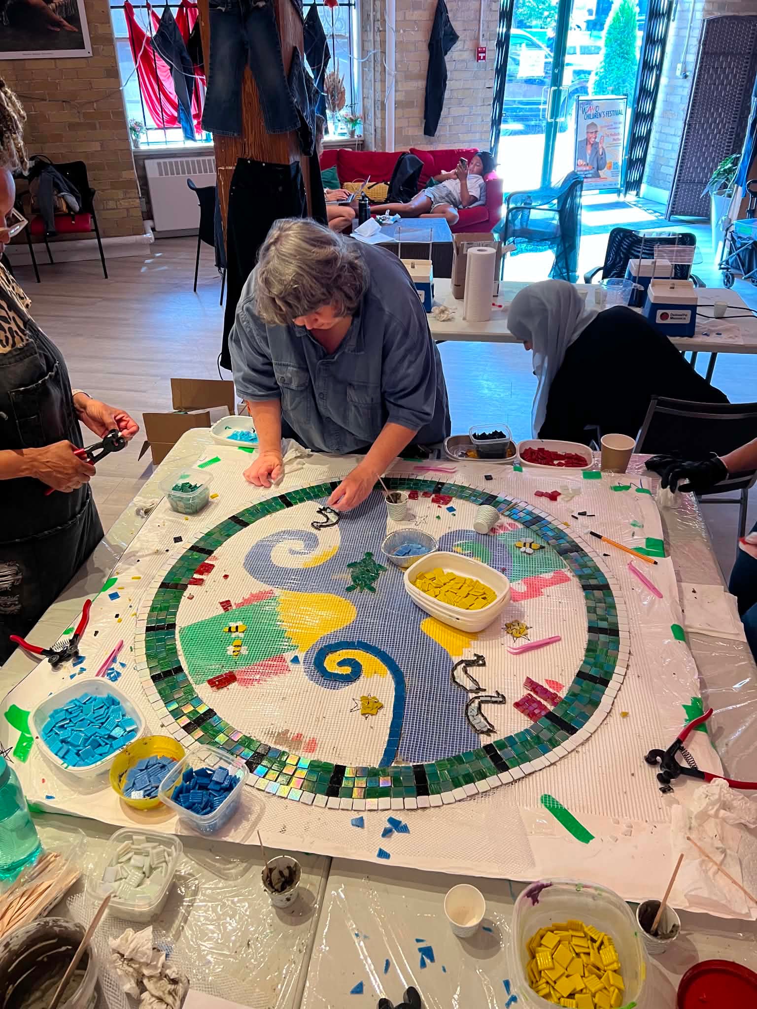 Want to be part of a permanent public artwork in Old Town Toronto?
This September, we’re opening our community mosaic project to all ages, giving new participants the chance to contribute directly to three mosaic-covered tables that will remain outside 262 The Esplanade.
Created with Alex Ganassini of @dolomitemosaics, the three designs explore Toronto before European colonization, industrial Toronto, and Toronto today, with the Don River flowing through all three artworks as a connection between past and present.
The designs are complete and production is underway. Now you can add your hands to the final artwork.
WHEN |
Thursdays, September 3, 10, 17
Wednesday, September 23
Thursdays, October 1, 8
TIME | 10am to 2pm
WHERE | The Jamii Hub, 264 The Esplanade
No mosaic experience needed. All materials provided.
Registration is required for new participants.
Children under 12 must attend with a parent or caregiver.
Photos by Alex Ganassini
#TheJamiiHub #AlexGanassini #DolomiteMosaics #JamiiEsplanade #OldTownToronto