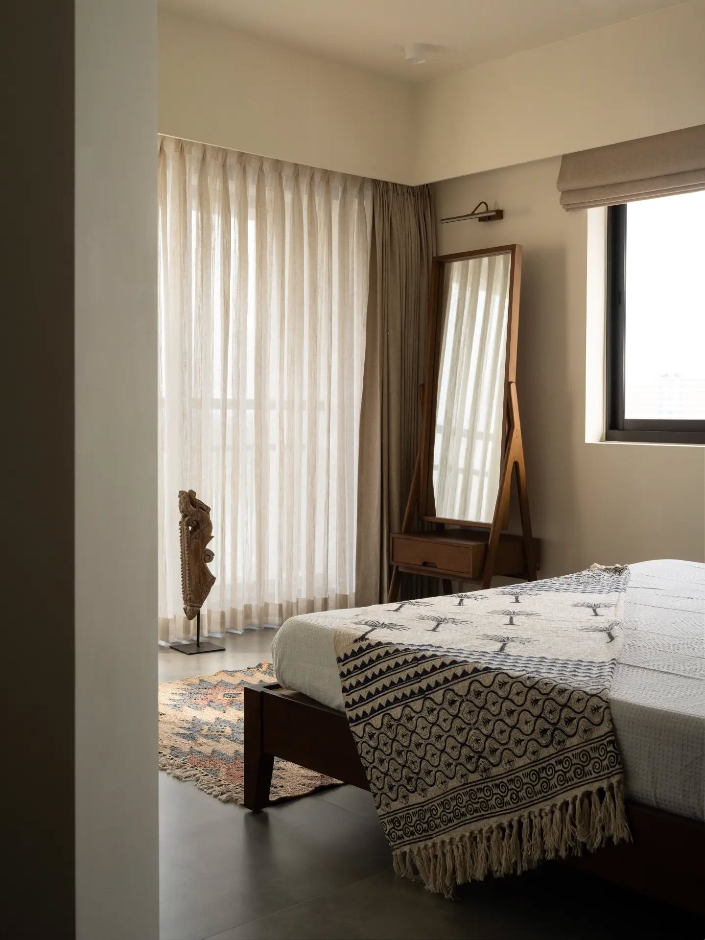 An intimate view of a bedroom where simplicity leaves room for character. Gentle daylight, flowing curtains, patterned textiles and thoughtfully placed furniture create a relaxed setting that feels both personal and composed.
Architect: @designnarrative.in
Decor: @foundobjects.in
Photography: @nathanphotos.in
Luxury furniture, handcrafted furniture, premium wood finishes, bespoke furniture, designer furniture, contemporary interiors, custom furniture, wooden craftsmanship, timeless design, elegant living, home interiors, The Lofts