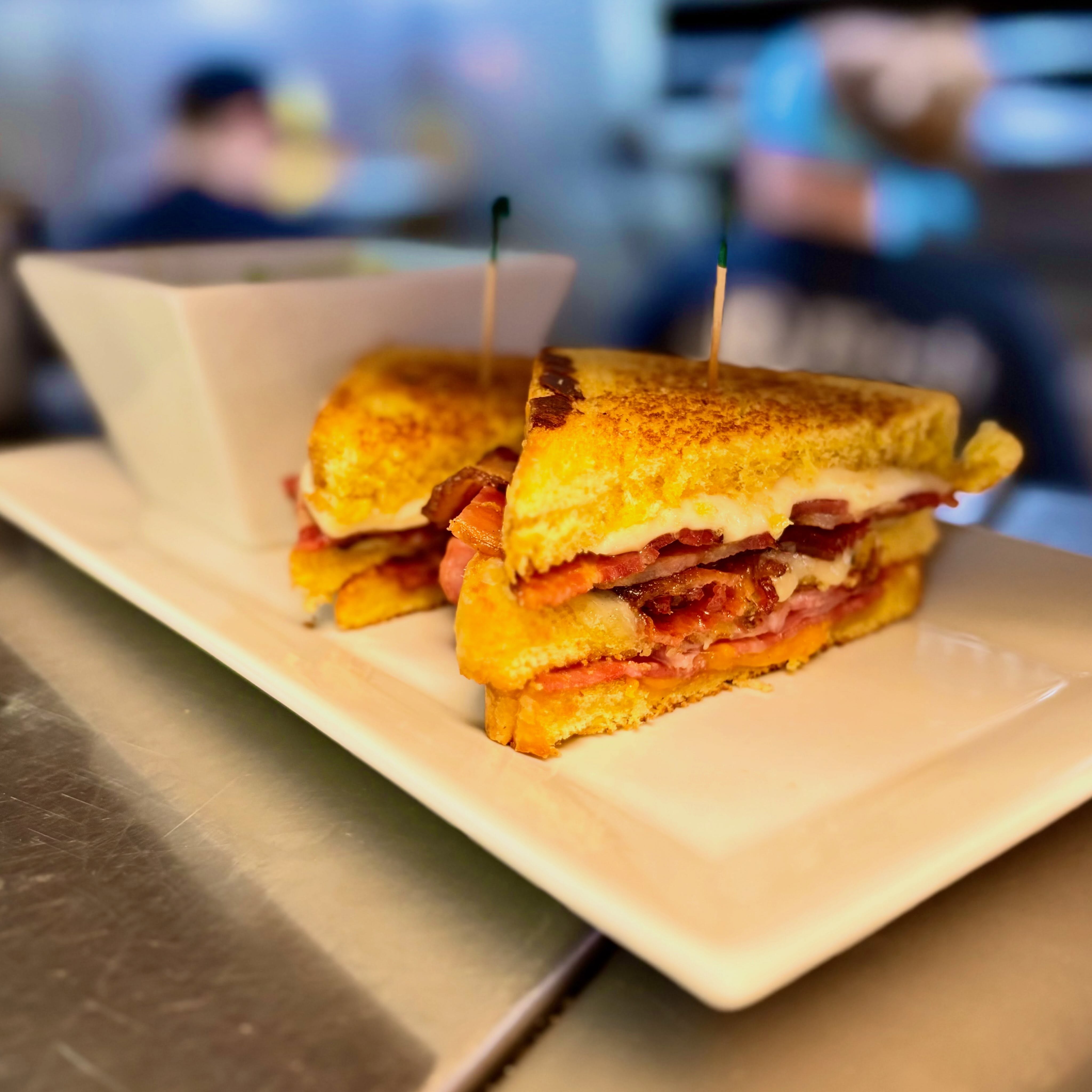 There’s a 70% chance of rain on Wednesday and a 100% chance this Triple Decker Grilled Cheese + Navy Bean & Ham Soup is exactly what you need while you watch it sprinkle! ☔️ The Birch forecast this week is looking pretty delicious!!
-
Lunch Special: Triple Decker Grilled Cheese
Three sliced of Texas toast with cheddar cheese, provolone and pepperjack, ham, bacon, and garlic aioli
-
Daily Soup: Navy bean and ham topped with green onions
-
Specialty Burger: Blackberry Burger
Grilled beef patty topped with brie cheese, Prosciutto ham, Blackberry compote, red onions, and arugula on a toasted bun
-
Birch Salmon: pan seared and topped with a stone ground mustard cream sauce, crispy fried Prosciutto ham, and green onions