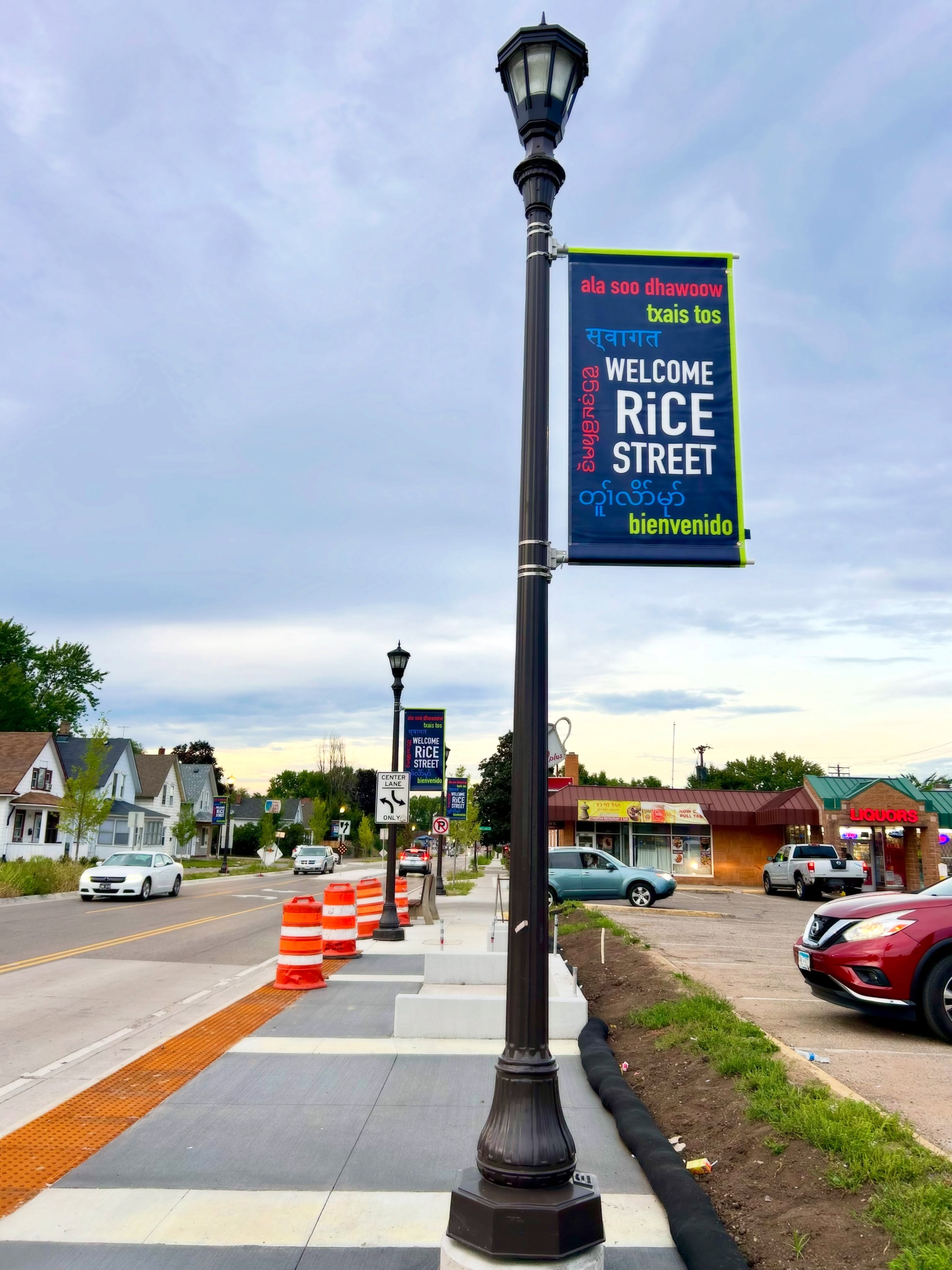 Hooray!! The “Welcome to Rice Street” banners are up from Maryland to Wheelock! The project will continue South of Maryland too as construction is completed. The banner design was overwhelmingly chosen by our community in an online poll. Welcome is in 7 languages including Somali, Hmong, Nepali, Karen, Karenni, and Spanish, demonstrating our pride in our multicultural neighborhood. ❤️
This project was funded by the City of Saint Paul - Commercial Corridor Program and installed by Ramsey County, as part of reconstruction. We are grateful to our partners North End Neighborhood Organization - District 6 for working together to make this happen.