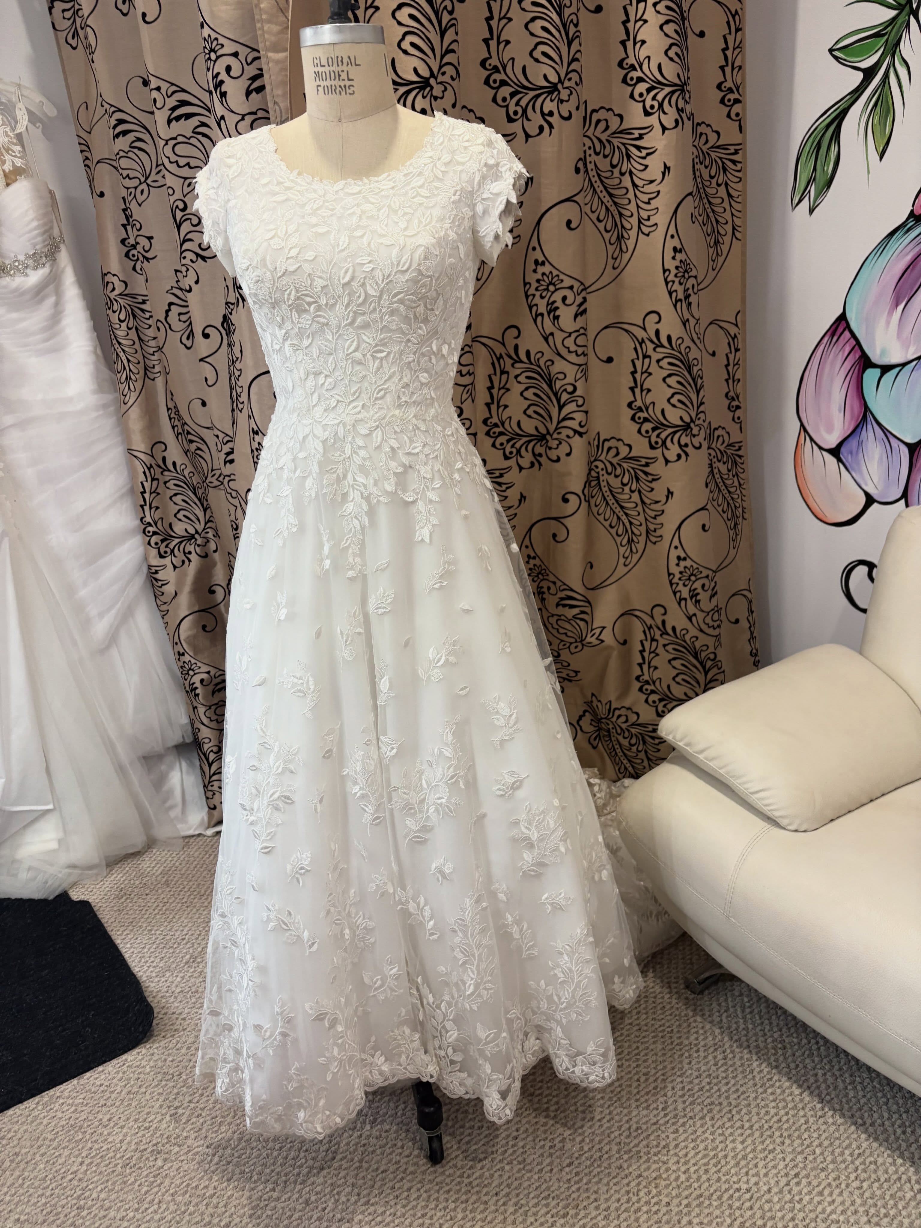 Consignment price: $1400
Retails $2000+
This gorgeous dress just came through the doors today! Will be freshly dry cleaned and ready for try ons as early as tomorrow. Stunning modest by mon Cheri in size 4. Hemmed to be about 5’2”.
Perfect for a bride looking for a bit more modest neckline and coverage. Absolutely STUNNING in person and so lightweight.
Has a 4 point bustle.