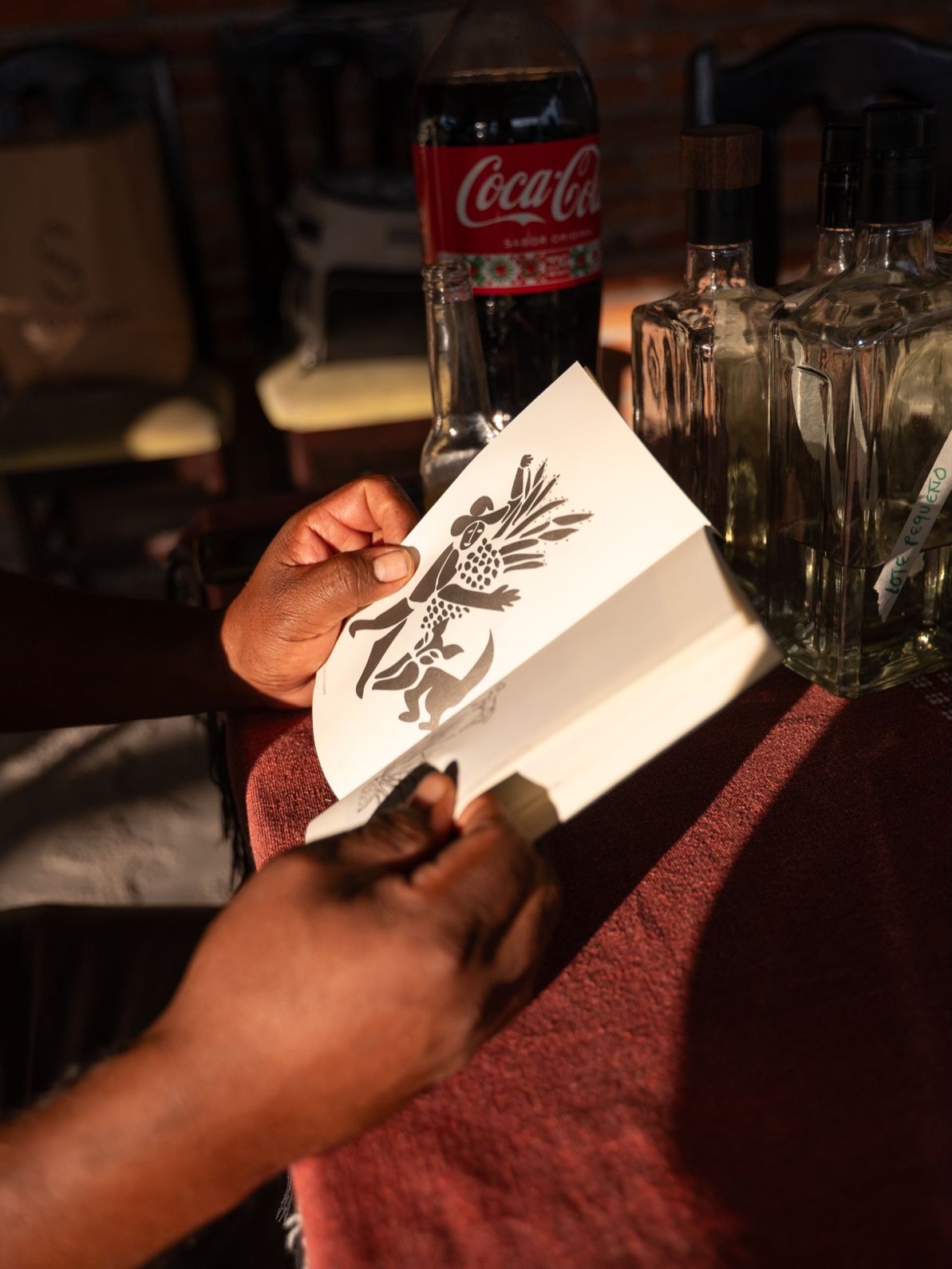 Jeronimo wirh his copy of @perrosypalenques - he is a dog lover and has some beautiful pups. A couple of years ago @caravanacanina hosted a campaign at his palenque, and one of the pups ended up getting adopted to @quiquigirl in the UK :) #perrosypalenques #distillerydogs #puppy #palenquero #mezcal