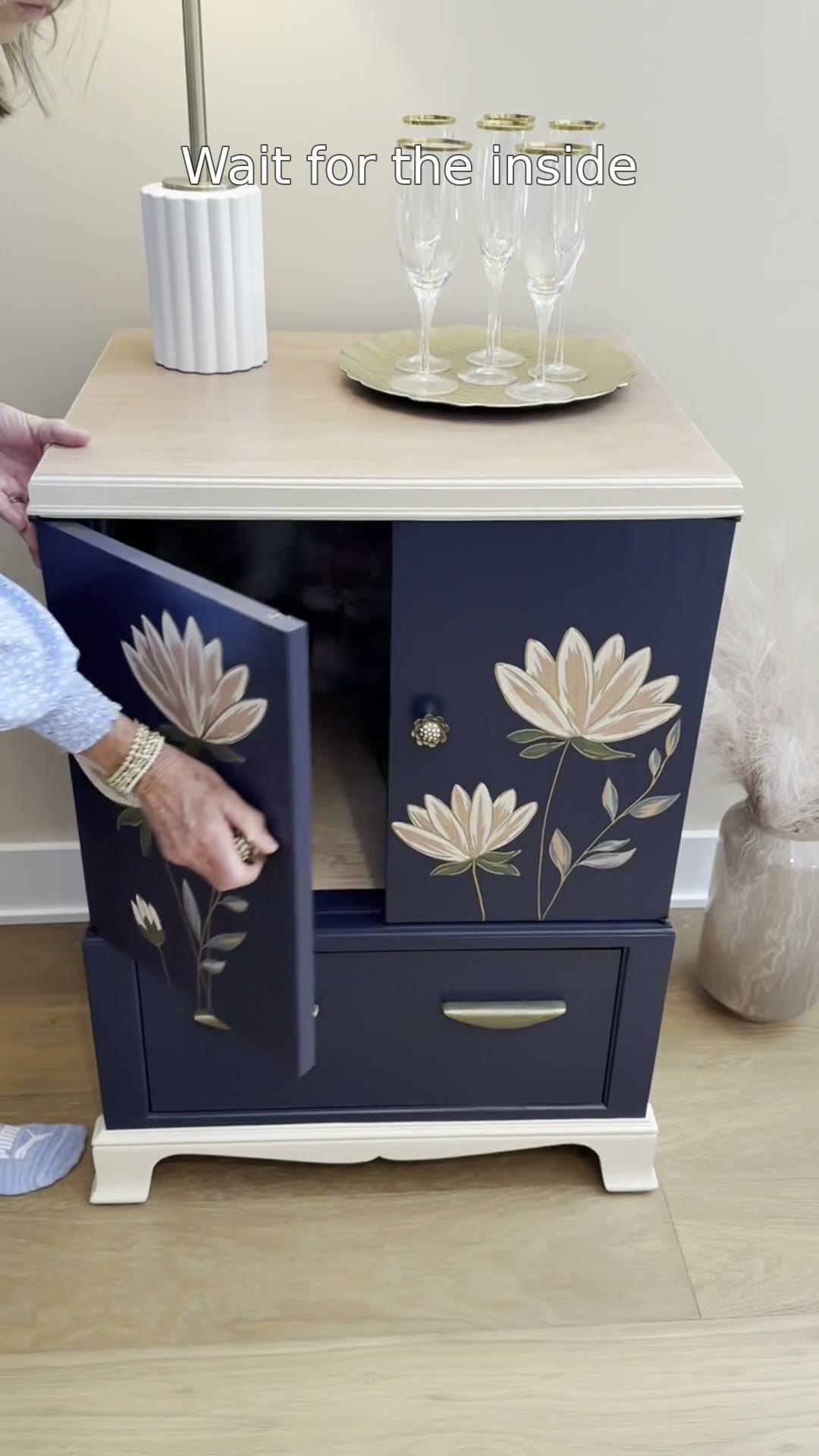 Wait for the inside 👀 Our Navy Floral Vintage TV Cabinet started life holding a television — now it's deep navy with hand-painted florals on the doors, floral wallpaper inside, and a drawer we added below. She's $475 and coming with us to Vintage Market Days in Myrtle Beach, October 2–4! DM us to hold her for booth pickup. @vintagemarketdayscarolinas #vintagemarketdays #twopoppiesdesign #paintedfurniture #furnitureflip
