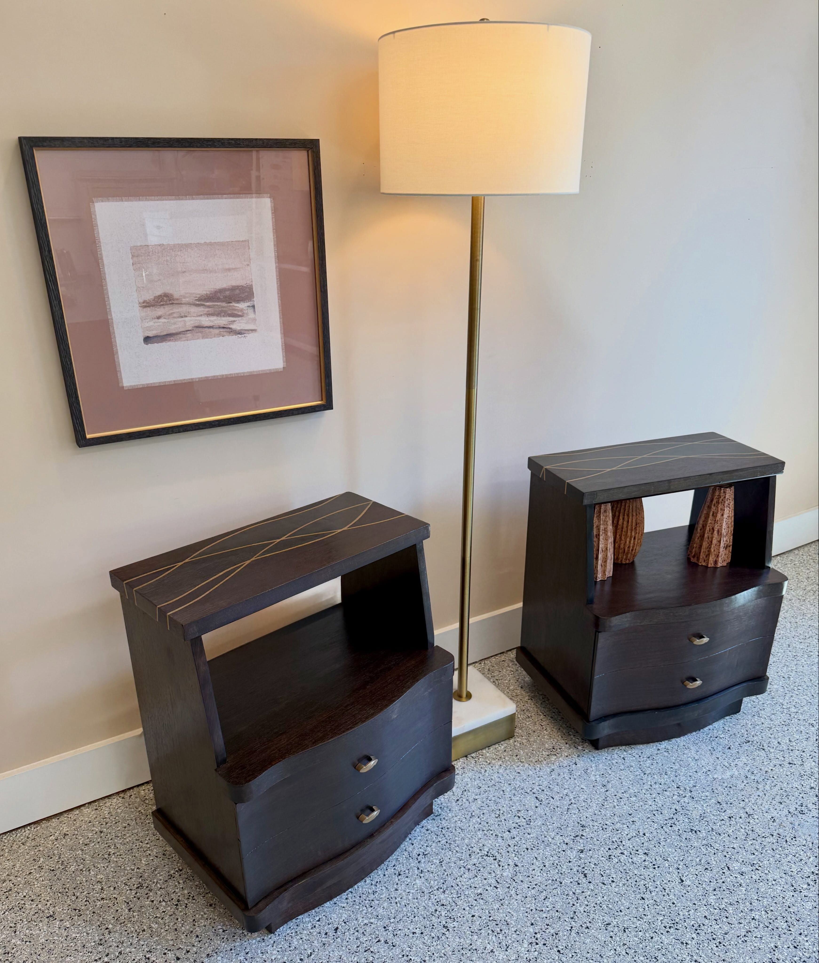 A true matching vintage pair is getting harder to track down, especially with slender lines like these. These mid-century nightstands feature a tiered profile finished in a rich, dark ebony stain that honors the original woodgrain. We preserved their original oblong drawer pulls with their subtle wave motif. Sized perfectly beside a low platform bed, framing a guest room setup. See them in person at @vintagemarketdayscarolinas at the Myrtle Beach Sports Center next month. #midcenturymodern #mcmnightstands #vintagenightstands #vintagemarketdays #bedroomdecor