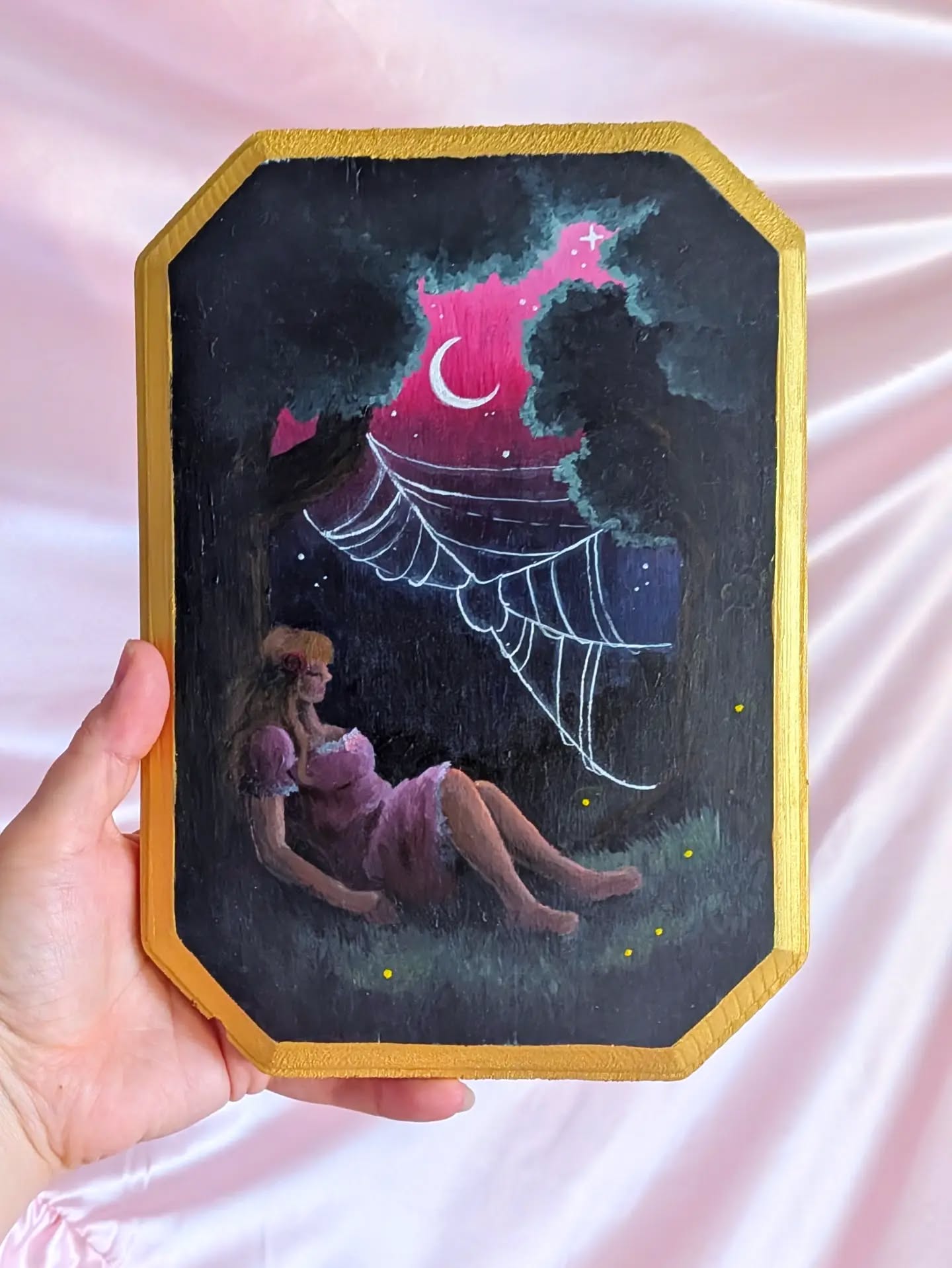 Finished a little painting this month 🩷🌙 "I'll rest a little longer" / acrylic on wood / 2026
I started this piece early this year when I was very very depressed. It's hard for me to make art when I'm sad -- my work isn't 100% happy all the time, but it is always about how I WANT the world to be. I have a physical aversion to turning my sadness into something visual that goes into the world. But I hadn't painted something in so long and really wanted to find the beauty in my sadness.
Originally, the girl was lying down in the grass, with her hair and limbs turning into the trees' roots.
As I started feeling better, I changed it to this pose, with the girl resting voluntarily, her hair coming out of the bark, maybe knowing she can leave when she's ready.
I later had the idea to paint her stepping out of the little forest cove. But I figured I'd never finish it if I just kept changing my concept based on my mood LOL.
Technically, I very rarely work with this much black! But it was a beautiful challenge to create the colors I wanted to portray in a night setting. I think I captured what I wanted to capture.
Thanks for reading and looking 🩷