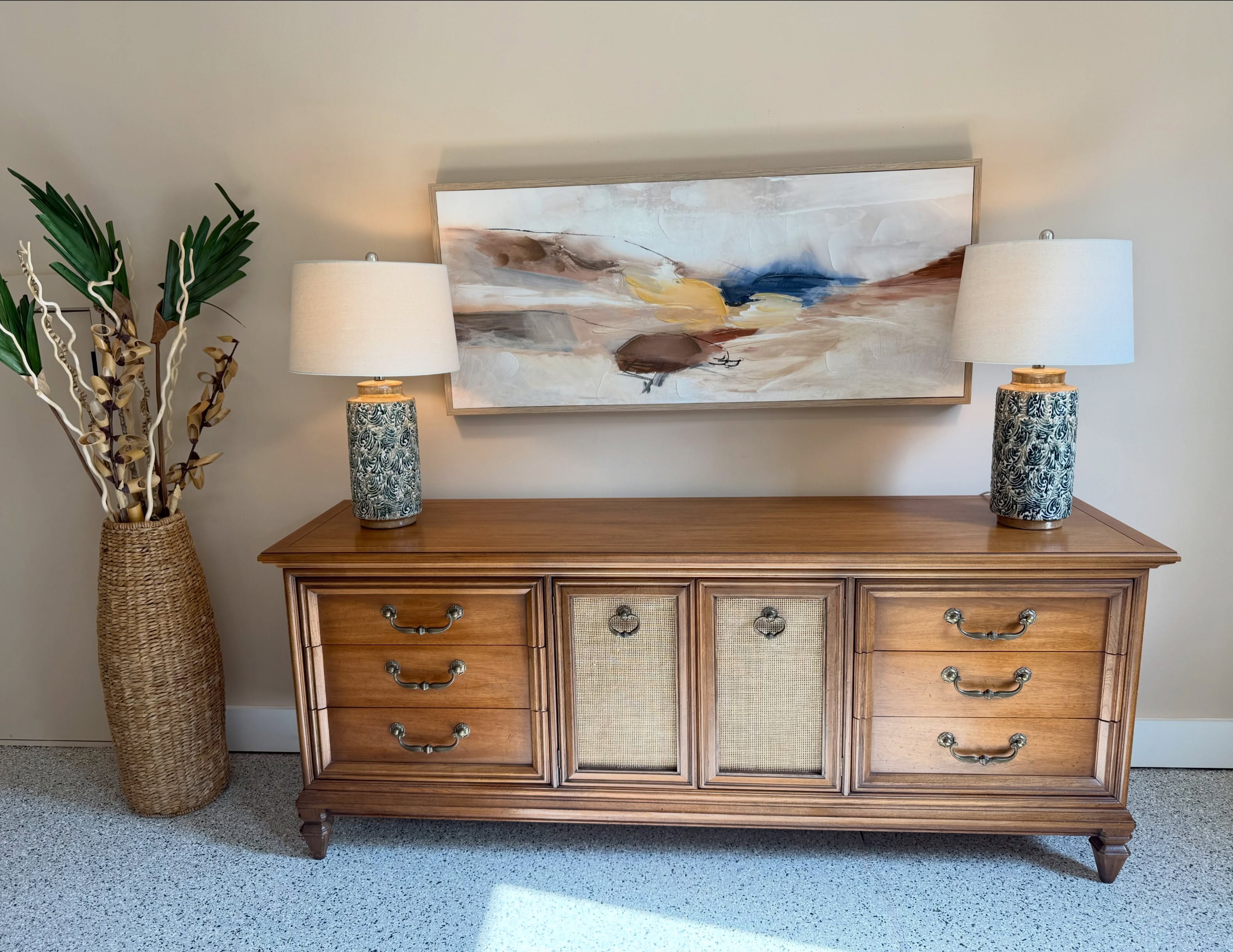 Meet our Vintage Fancher Sideboard/Dresser — a real showstopper! Warm wood tones are updated with a touch of new by adding woven cane door inserts and finishing with the original mid-century hardware. Nine drawers of storage give this piece serious dining room or entryway presence. Symmetry, character, and craftsmanship that only gets better with age. This one’s heading to Raleigh for @vintagemarketdaysofnctriangle in mid-November — come see it in person at the holiday market.
#vintagefancher #sideboard #midcenturystyle #twopoppiesdesign #vintagestyle