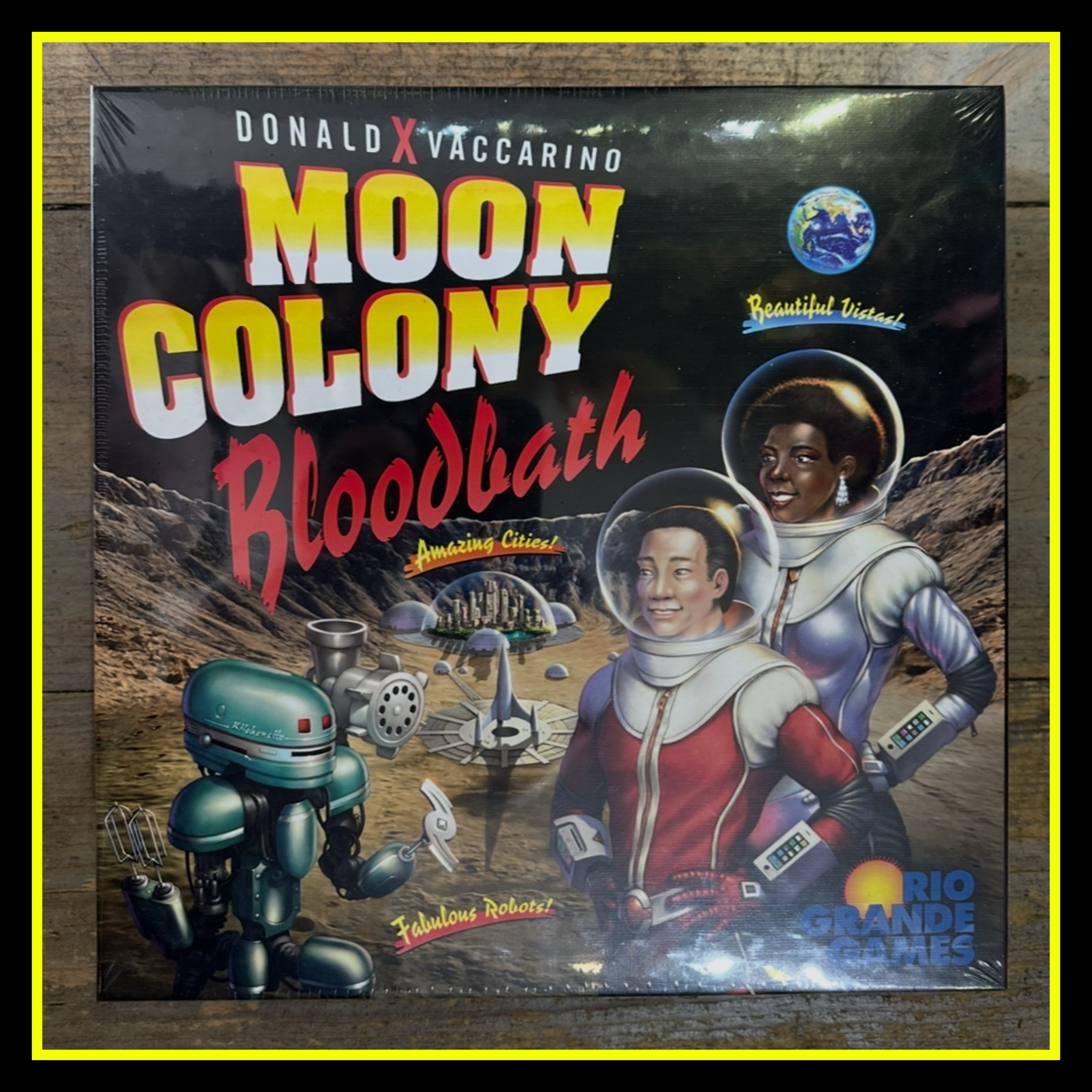 Moon Colony Bloodbath is an engine-building, engine-losing tableau game, with a shared deck the players build that makes things happen, many of them bad things that kill people in your moon colony, but some positive, and some that let you build up.
More specifically, each turn one card is revealed from the shared deck, which starts with four work cards, two trouble cards, and two twists. For work, each player takes an action of their choice simultaneously: mining for money, farming for food, research for cards, build a new building, or restock boxes on buildings. Twists vary from one game to the next. Trouble adds a new event card to the deck: hunger, paperwork, glitches, accidents, leaks, power failure — whatever can go wrong will go wrong, then whenever the deck is shuffled, you can prepare for all those events once again.
Players can add cards to the shared deck, too, whether perks that are only for you or developments that affect all players.
The game lasts until one player’s moon colony has no people remaining, or until the players reach the bottom of the event deck. At that point, the player with the most survivors wins.
We’ve got boardgames, clothing, accessories, collectibles and more.
C’mon down to 2307 East Hastings in Vancouver or place your order via shop@thegoodsapparel.com or by messaging us on instagram or facebook. We ship all over Canada