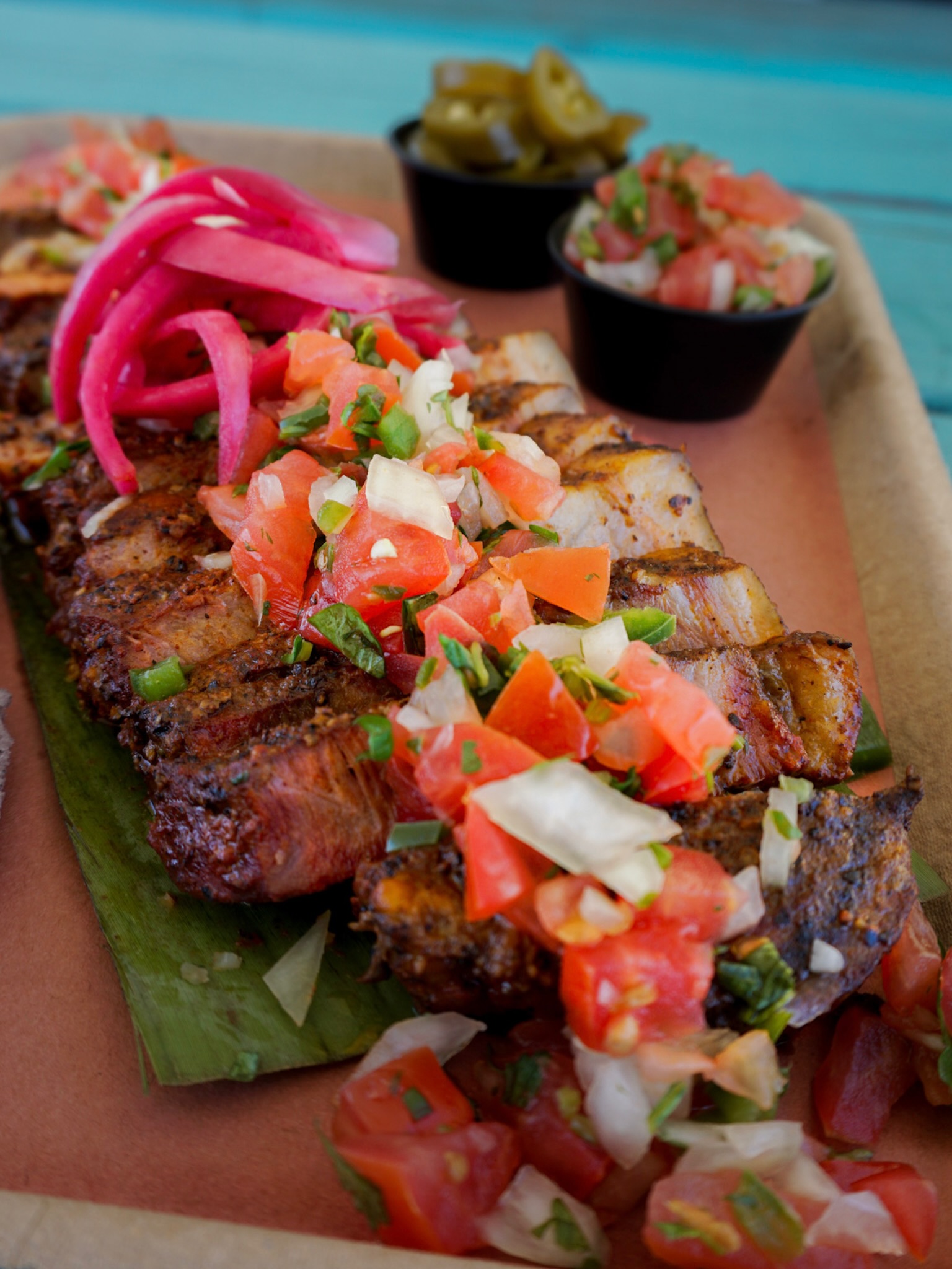 Have you tried the El Conchinito?
This pork marinated in an Anchiote Paste is topped with Pickled Onions and Pico De Gallo - the perfect mix of BBQ and Hispanic heritage!