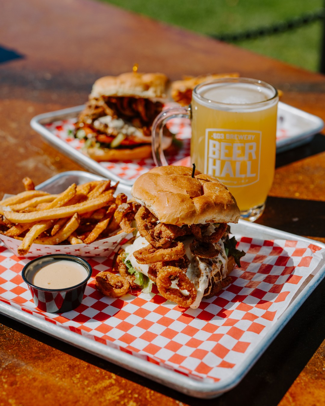 It's a beautiful day for a TGIW! Our Italian grilled chicken sandwich brings savory, herb-marinated chicken, creamy fresh mozzarella, and fried cherry and banana peppers together with the bright, zesty kick of lemon parsley aioli. Pairing with a classic, Scenic IPA, it's vibrant guava, grapefruit, and tangelo notes complement the sandwich’s fresh and savory flavors, while its smooth, refreshing finish and gentle hop bitterness cut through the richness of the mozzarella and aioli. A refreshing New England pairing that brings a little sunshine to every meal out on the patio! This is one you won't want to miss!