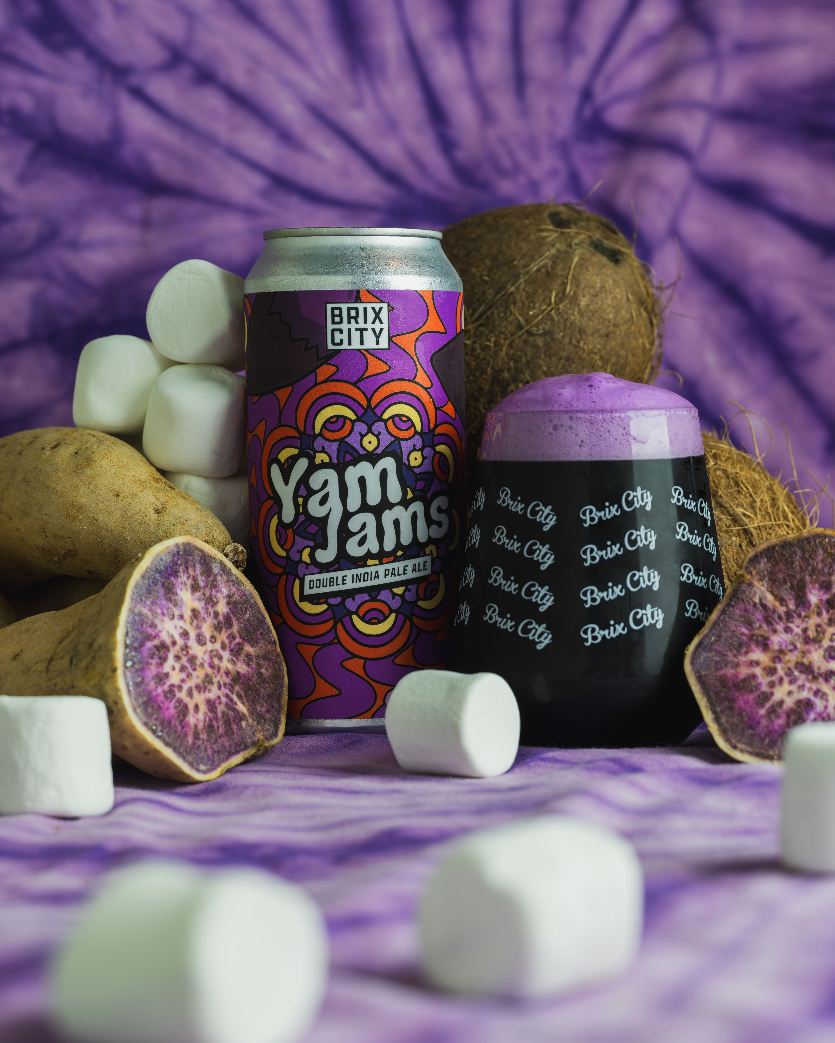 Available soon via our distribution partners:
**Expect a list of places you can find cans of this beer in about 2-3 weeks.**
After a 3 year hiatus, this fan favorite returns just in time for fall…
Yam Jams is an 8% ABV Milkshake style DIPA inspired by the popular Filipino dessert - Ube Halaya. Known for its distinctive purple color, ube is a yam native to Southeast Asia. Ube halaya is made with ube that is boiled, mashed, and combined with butter and a sweet milk (typically coconut or condensed). This richly flavored jam (no pun intended) can be eaten on its own or used as a base in pastries, ice cream, and other desserts.
For our take on this sweet treat, we brewed up our usual Jams base, added a healthy dose of creamy Lactose, Double Dry Hopped with some Citra and Mosaic, and finally conditioned the liquid on an insane amount of Ube Purée, fresh Coconut, Marshmallow, and Vanilla. This beer pours a uniquely deep dark-purple color and is topped by a creamy, violet-colored, head. Upon tasting Yam Jams, we’re finding notes of sticky melted marshmallows layered between shredded coconut, tangy tangerine slices, sweet tropical smoothie, and a distinct nutty flavor from the ube.