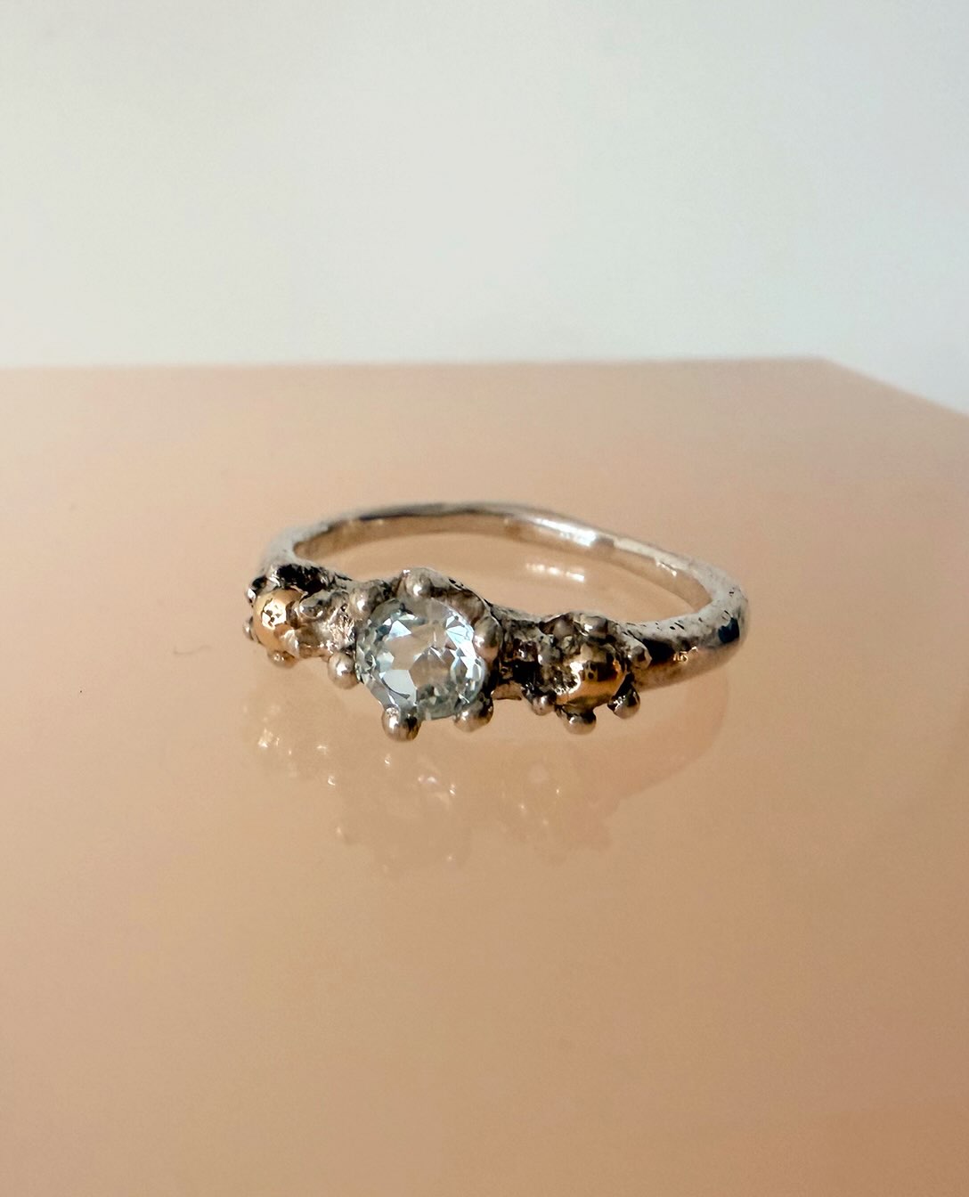 NEW COLLECTION
I named this ring after the King of the sea, although I feel it’s more of a queen! But it reminds me a bit of a crown and the gemstone in the middle is a beautiful clear, briljant cut aquamarine. The ring itself is silver with 14k yellowgolden dots. Also perfect suitable as an engagementring!
€ 595,00 and available in my webshop!