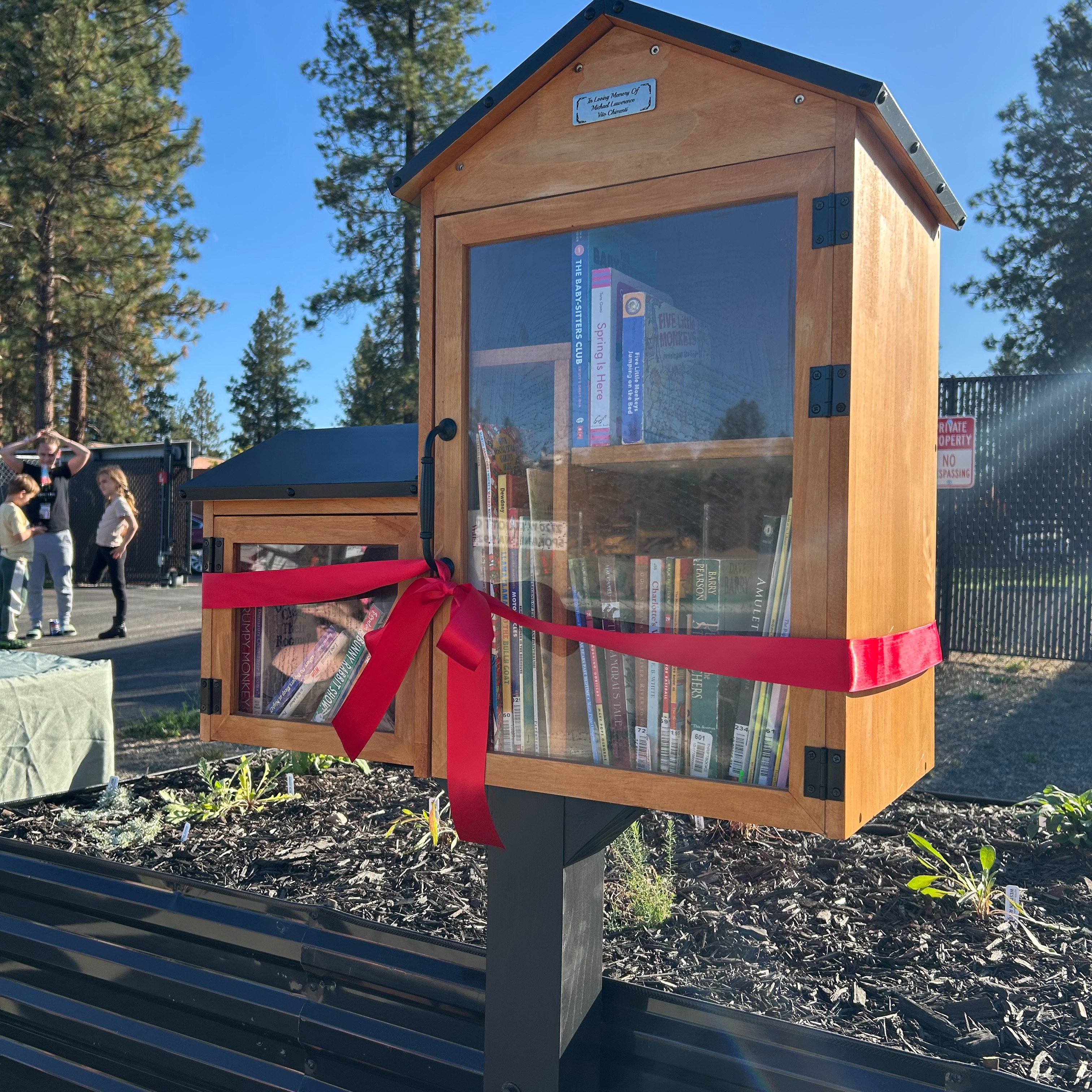 Thanks to a generous donor, Catholic Charities Eastern Washington has opened a Community Little Library in a cul-de-sac garden outside some of its properties in West Spokane.
This public resource will be on display in a garden at the cul-de-sac where Rising Strong, Community Behavioral Health Services, and Mother Theresa and Sister's Havens connect. In the near future, the library will face River Haven and serve the Salish school families when those projects are built.
The Little Library honors Michael Lawerence “Vito” Chimenti as a father who loved to read to his children and had a heart for the vulnerable. A $4,000 donation from his estate has allowed CCEW to purchase books and regularly stock this great resource for children in this neighborhood while supporting literacy, community and imagination.