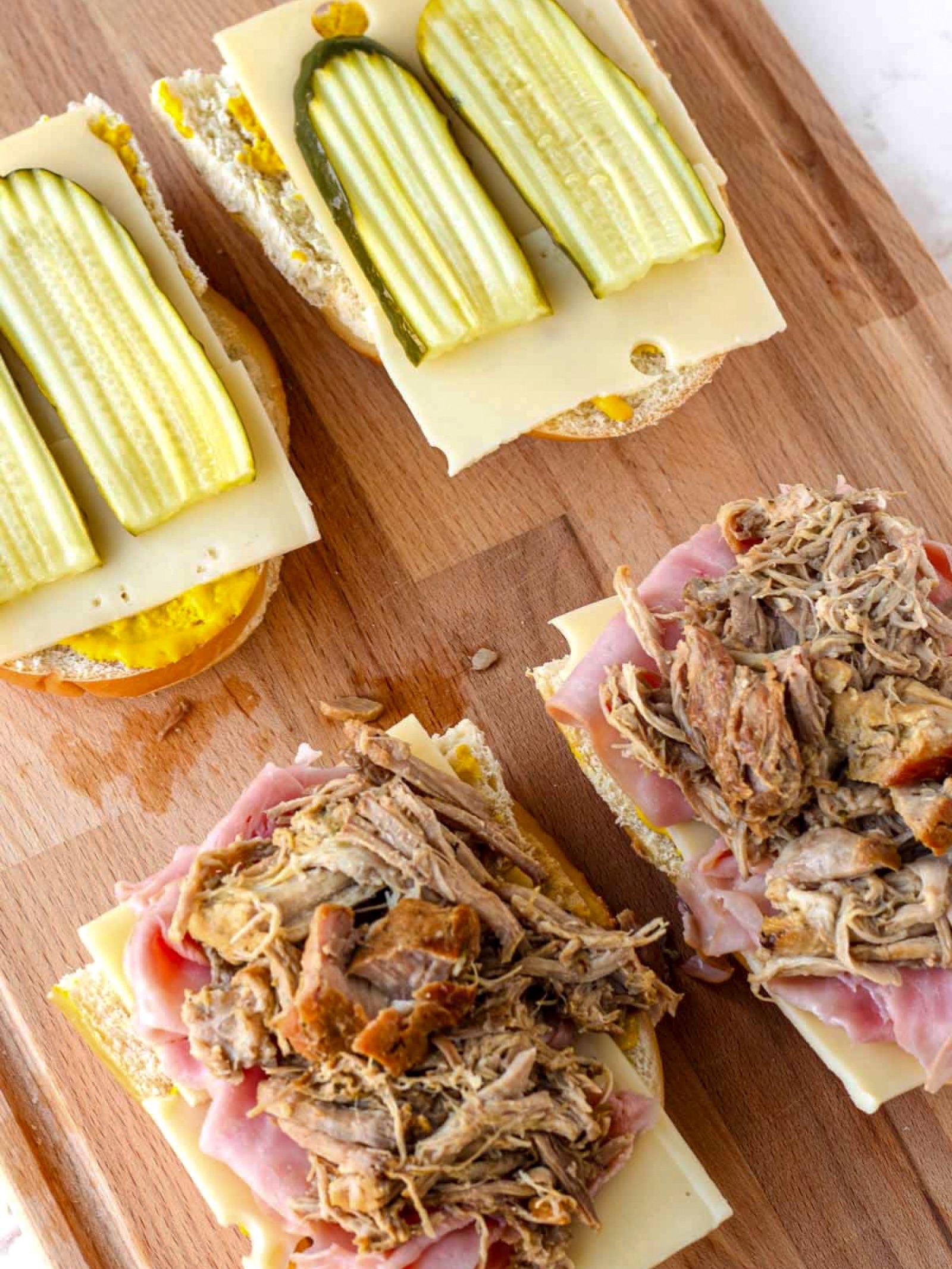 A Cuban classic, Blue Magnolia’s way!
There’s something nostalgic about a perfect Cuban sandwich, and ours begins with a recipe that has been passed down through generations.
Tender pork, sweet ham, melted swiss cheese, pickles, and a touch of mustard, all pressed together to make an irresistibly delicious sandwich.
Our Cubantia sandwich board (or lunch box) is suited for a casual beach day, yet polished enough for an elevated bonfire soirée.
The best gatherings call for food that feels effortless, familiar, and unforgettable. 🇨🇺🥪