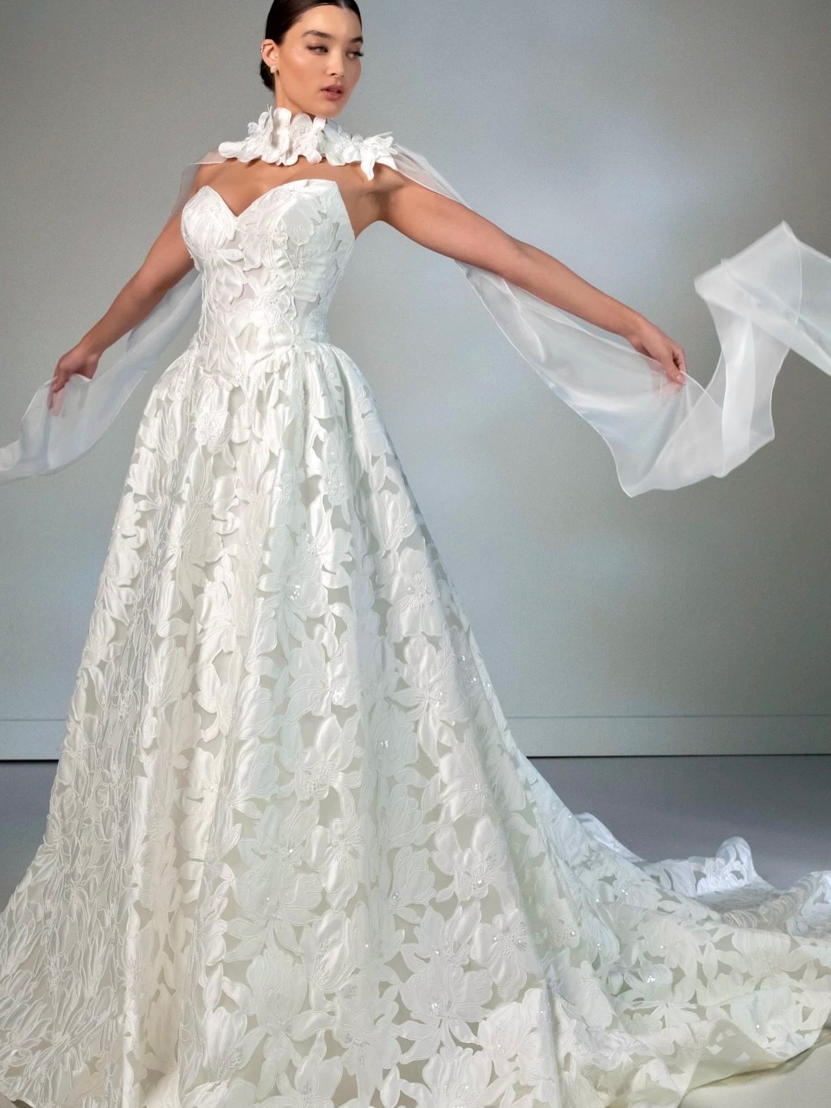 Modern lace meets couture florals in this regal A-line gown from @martinalianabridal 💕🌸 Front and center in our boutique, she’s even more gorgeous in person with a classic sweetheart neckline and the ethereal lightness of organza.
A detachable lace and organza neck shawl drapes elegantly over the shoulders for a touch of high-fashion drama, as its intricate 3D floral accents create a stunning, cohesive look.
📲Appointments available by phone or at the link in our bio.