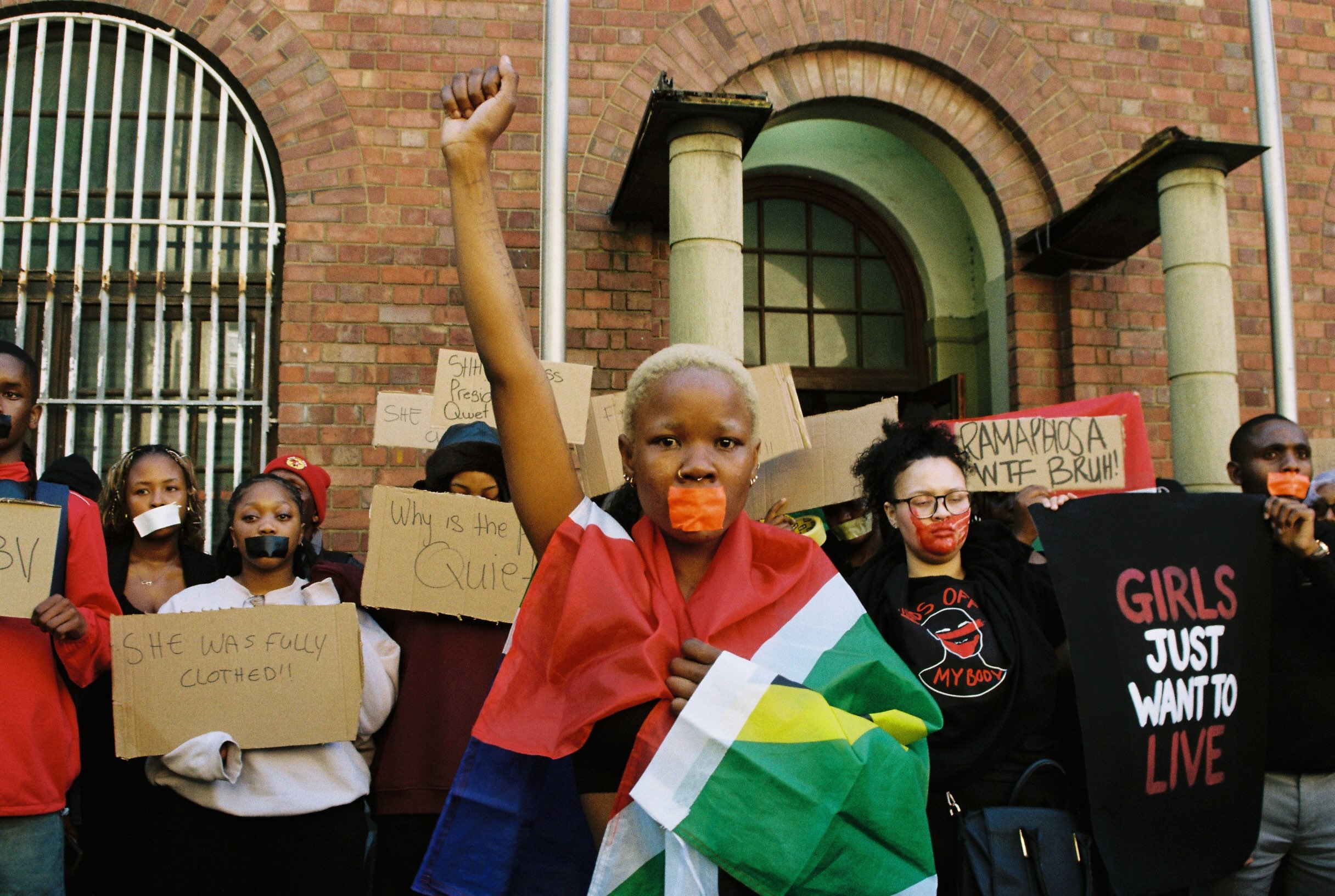 “The women of South Africa are fed up. Today, you may be silent, but your silence is louder than anything you can say”.
South Africans have been shocked to the core after a relentless week. Nine women have been found dead in Kempton Park in Gauteng in such a short period that many women in the area, let alone the entire country, are considering whether to go for their normal jog or go on about their day.
‘Femicide’ is not a new term for South Africans. Gender based violence is a massive issue in South Africa, where sexual offences are sky high and cities such as Johannesburg and Pietermaritzburg rank in the top 5 of world’s most dangerous cities.
Despite being known for its’ greater level of safety, walking home at night for a woman is avoided in the city of Cape Town.
On Tuesday, 15 September, @ngwanako_kasii announced a silent protest for the next day in Cape Town City Centre that she believed only her friends would come to. At this point eight women had been killed.
To her surprise, over 100 people showed up with cardboard signs. Fear, anger and resentment of this constant cycle SA women keep going through drove passion and community.
“I was 19”
“I was 6-my sister was 9”
“I was 12”
Women yelled as they vented the age they had been sexually assaulted for the first time.
16/09/2026
Shot on 35mm Kodak Gold
#femicide #southafrica #gbv #protests #capetown
@thekiso_mokhele
@ngwanako_kasii