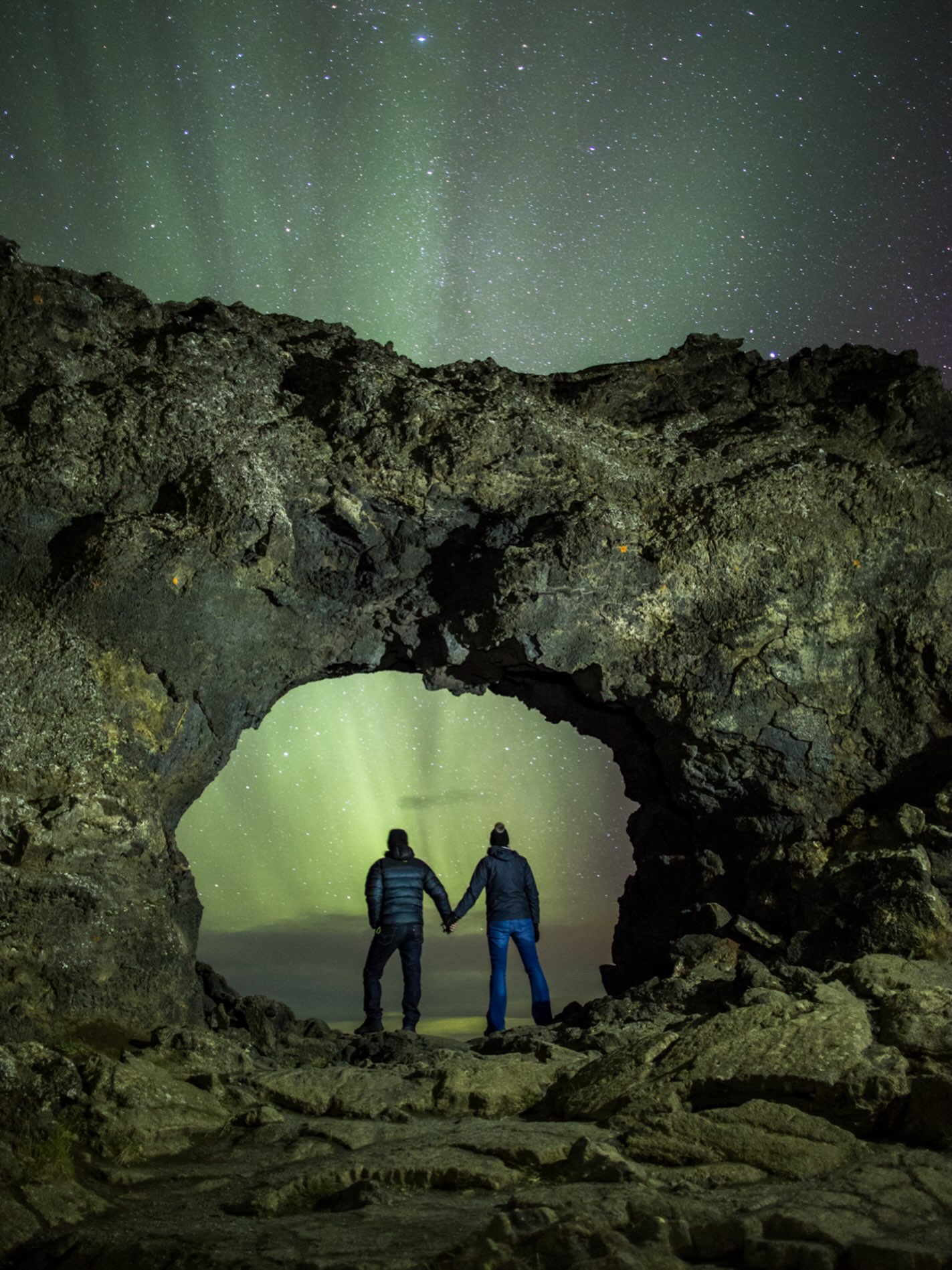 Honeymoon under the Northern Lights. This is one of my favourite moments under the northern lights, This lovely couple was here on they're honeymoon when this happened. Inside Dimmuborgir Arch " Gataklettur #photography #iceland #aurora #honeymoon #myvatn