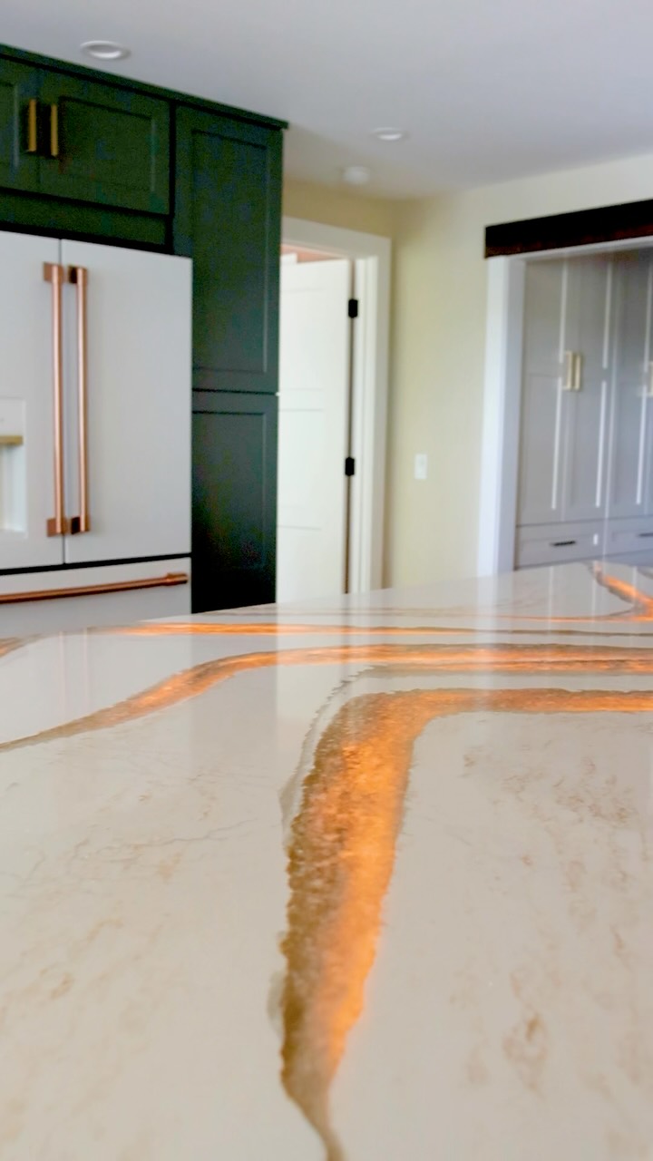 This countertop is everything! This stunning @cambriasurfaces Britannica Gold countertop from @blasius.countertops_ was a standout in this whole-house renovation. The custom backlighting brings the natural veining to life, creating a unique glow throughout the space.
The fabricators carefully chiseled out the veins to make them more translucent, then @btelectric added LED lighting behind the stone to illuminate those areas. A pretty incredible process, and an even better finished product.
Michigan Contractor | Custom Builder | Backlit Countertop | Countertop with Backlighting | Countertop Light | Frankenmuth Builder | Custom Kitchen