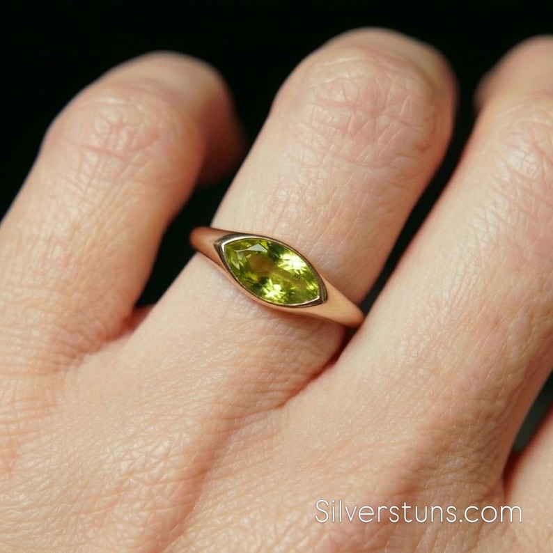 ✨ The perfect pop of color. Meet our new Marquise Bezel Peridot Ring. ✨
Exquisitely crafted in 14K Solid Gold, this minimalist signet ring features a stunning 1.5ct marquise-cut Peridot in a secure bezel setting. Whether you’re celebrating an August birthday, looking for a unique promise ring, or simply love a modern, elegant statement, this piece is for you. 💚
Minimalist in design, maximum in style.
Shop the link in our bio to make this beauty yours! 🛒💍
#PeridotRing #MarquiseCut #14KGold #SignetRing #MinimalistJewelry PinkyRing AugustBirthstone BirthstoneRing RingsoftheDay StackingRings GoldJewelry FineJewelry GiftForHer UniqueRing