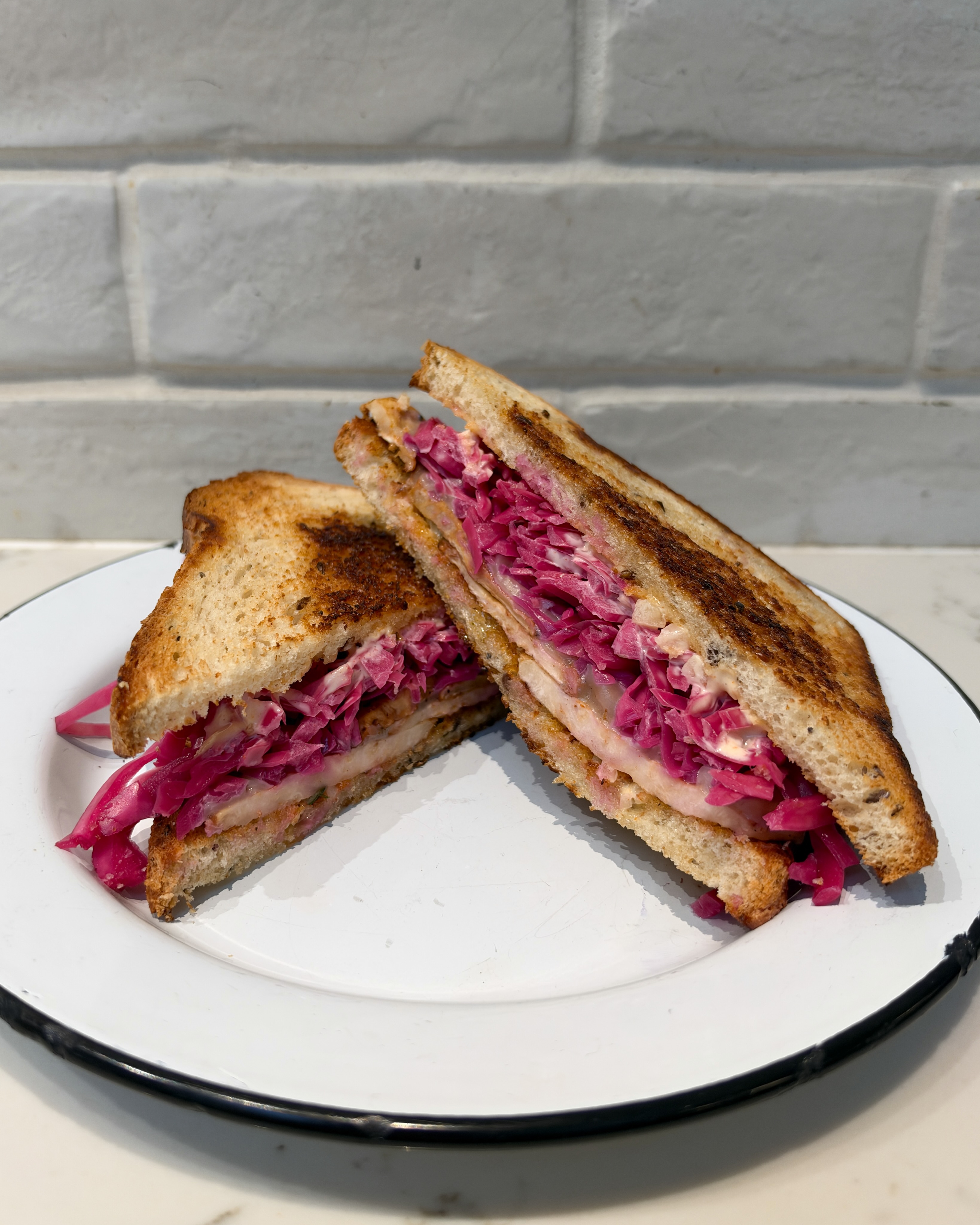 Meet the new Veggie Reuben. Roasted + spiced celery root, Russian dressing, pickled cabbage, gruyere, all stacked on Bigwood 9 grain bread.