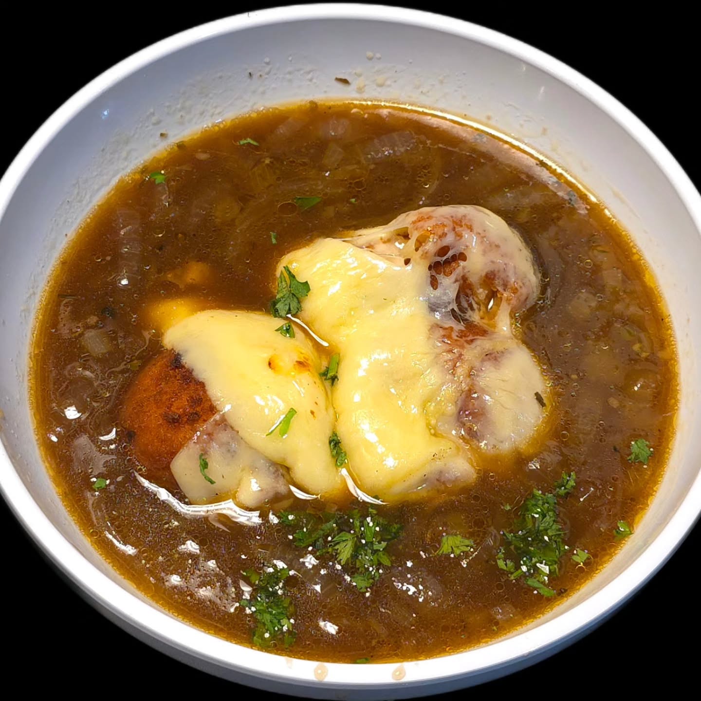 Arancini French Onion Soup🍴French onion soup with two cheese-stuffed rice balls, topped with Swiss cheese