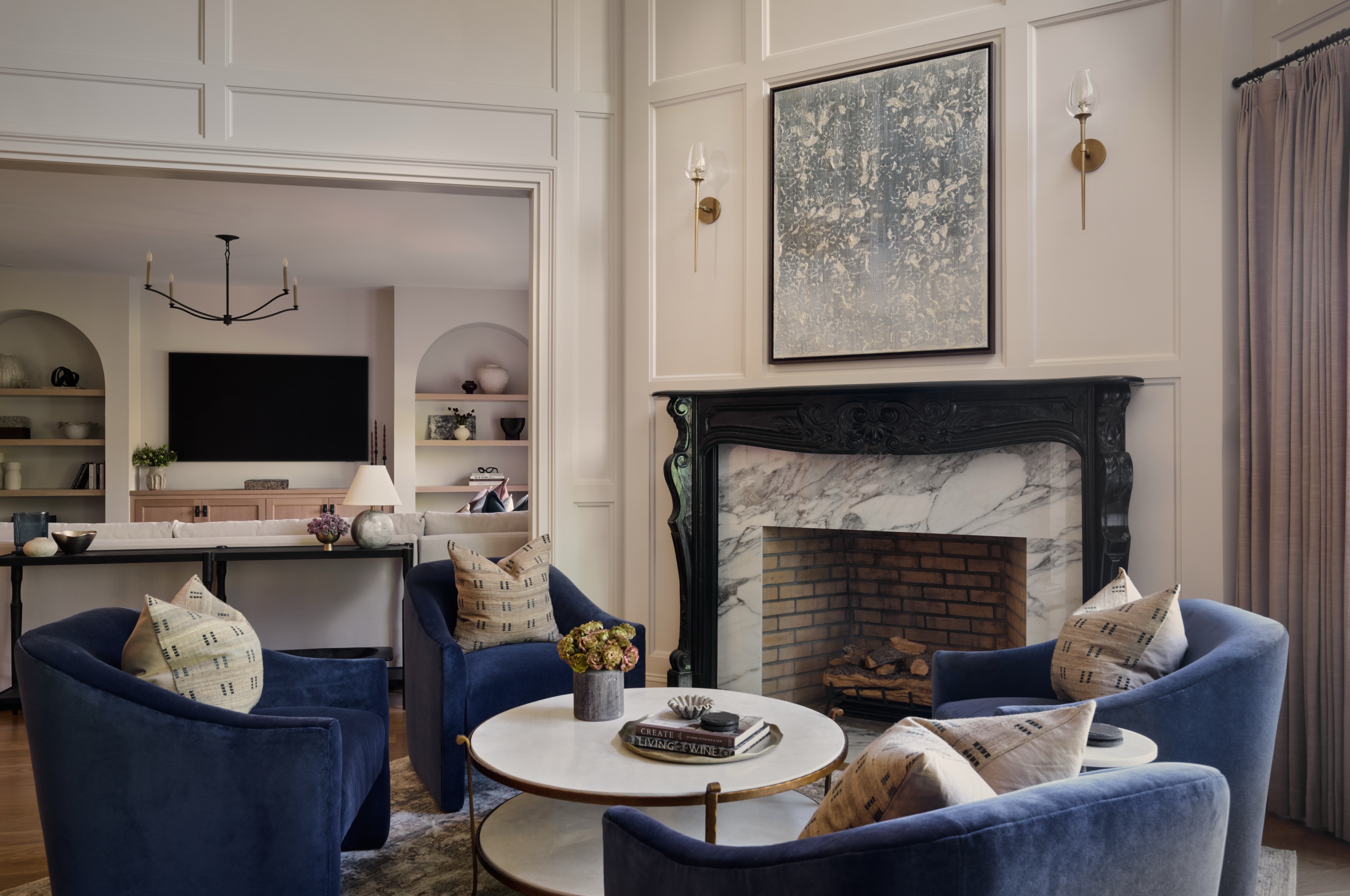 For our Bordeaux Road Project, we kept the original ornate fireplace mantel and painted it black, and redesigned every inch of the space surrounding it, adding marble, sconces, and wall paneling that draws your eye up to the high ceilings and brings so much warmth into the space.
The finishing touch was creating an inviting seating area made for cozy nights and gathering together.
Photography: @paul.s.bartholomew
#njinteriordesigner #njdesigner #customhome #designservices