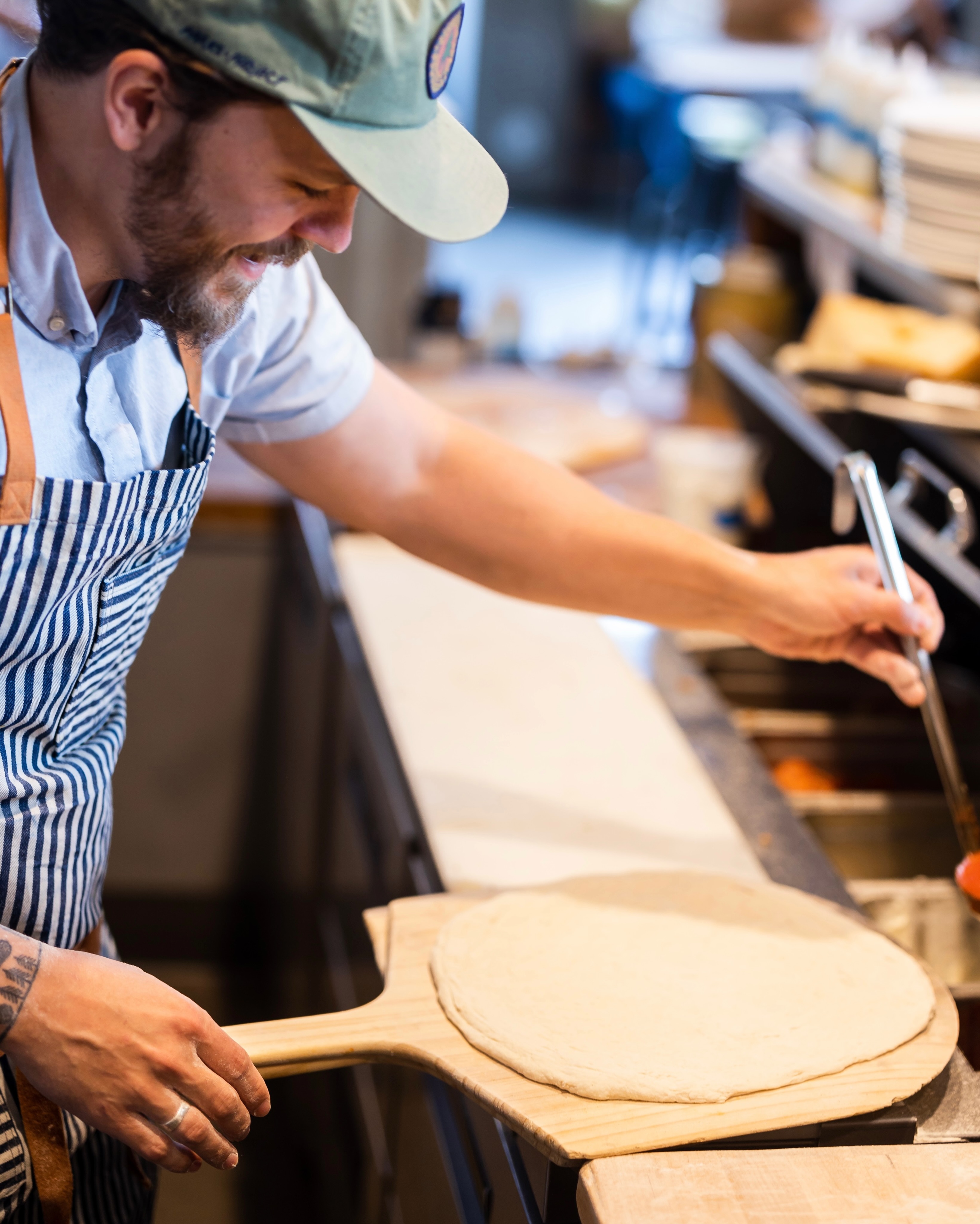 Every pizza starts right here. Dough made in house, stretched by hand, and ready for the oven.