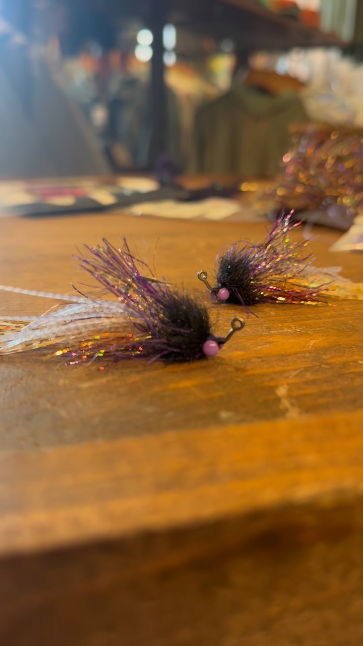 The Uncrustable: for when the local rule of thumb is either black and purple, or gold and flashy…why not do both?
Hook: #1 Mustad J60AP Hard Head Jig
Thread: Danville waxed flymaster plus 140denier in Purple
Weight: Lead free wire .015
Tail: Fulling Mill Golden Shiner legs, Rusty Ice Dub and Chicone’s Wide Crusher legs in barred clear/purple
Body: SightCast Holographic Wrap in purple/gold, and 1” EP Tarantula brush in purple/black
Eyes: Hareline Brass Eyes in purple
